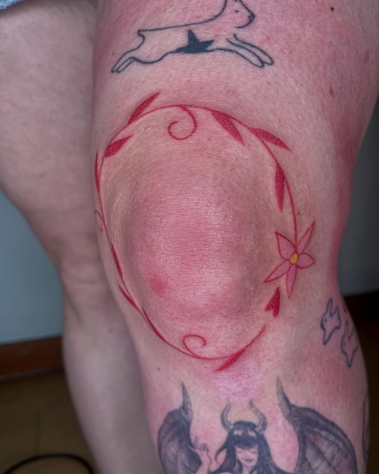 Flower and vine dotwork tattoo on the thigh by Jenna