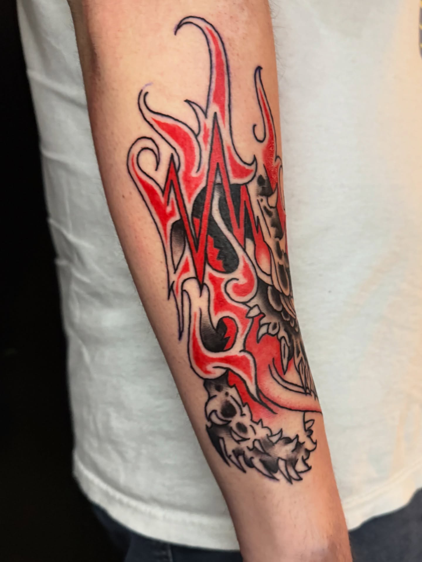 Flame American traditional tattoo on the forearm by Gabe Rosen