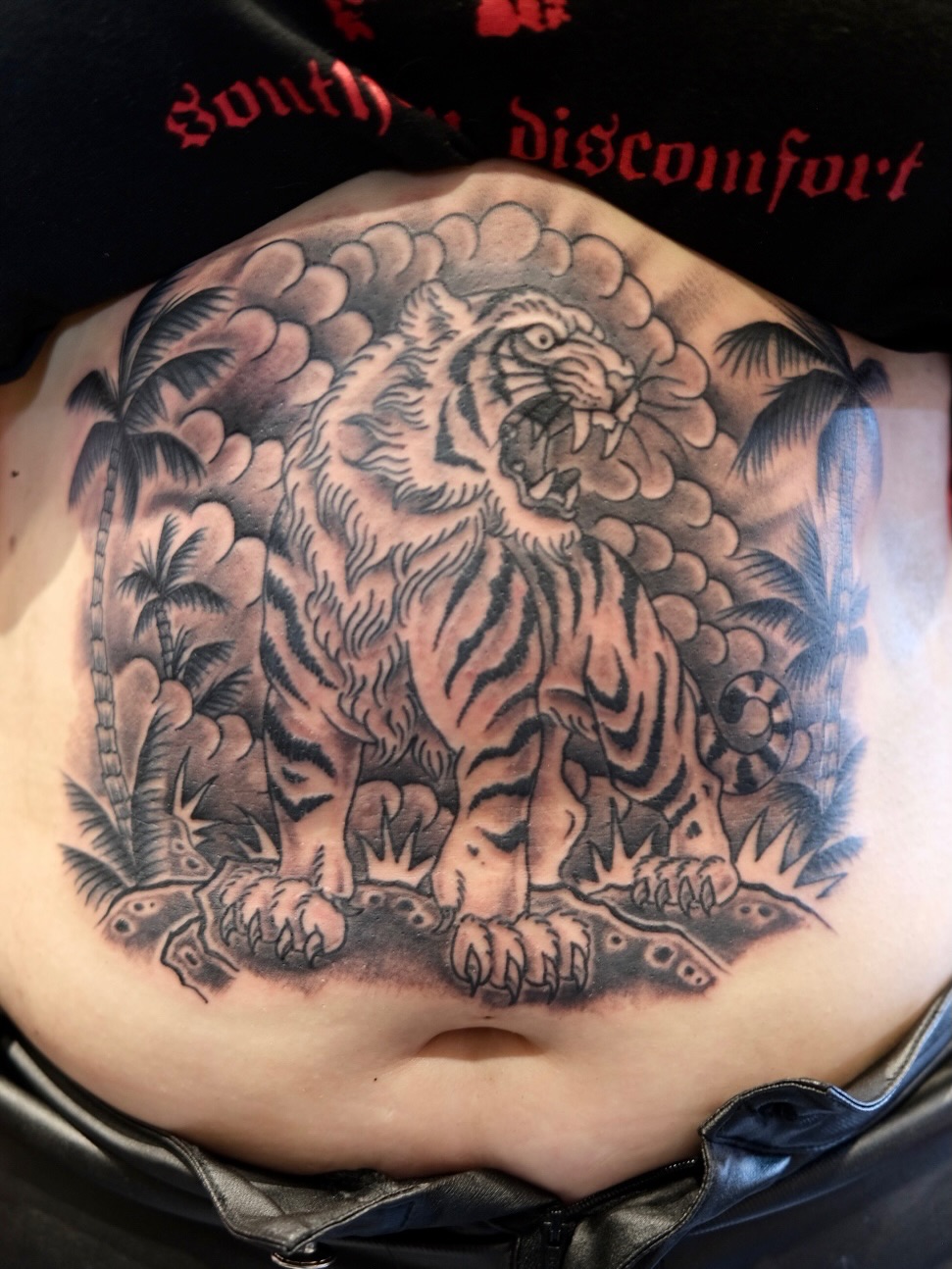 Tiger American traditional tattoo on the torso by Zak Colburn
