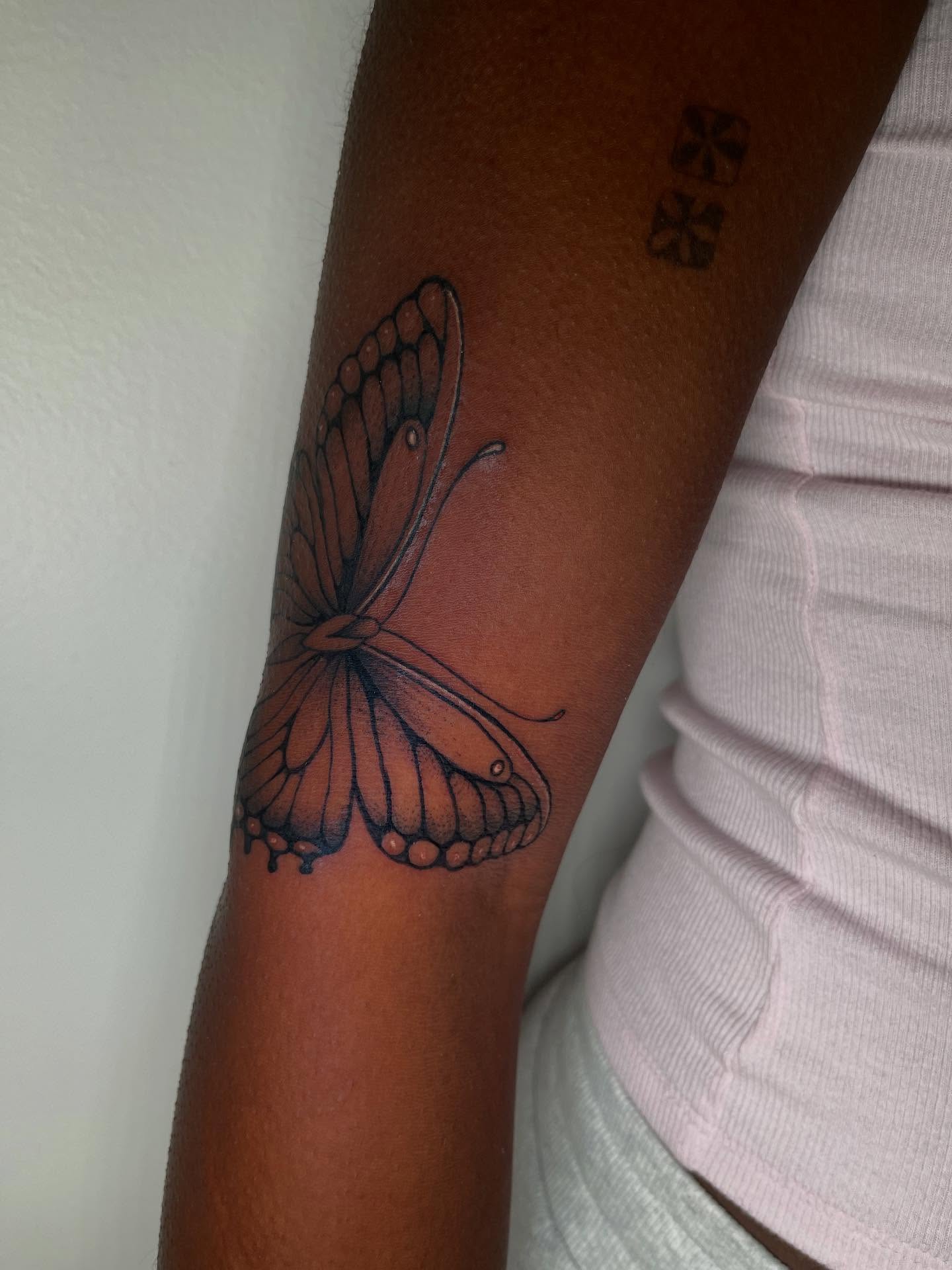 Butterfly black and grey tattoo on the forearm by Elisa
