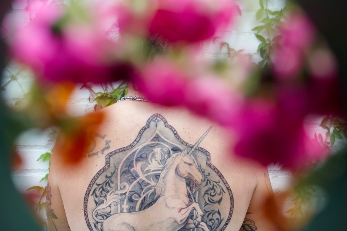 Unicorn black and grey tattoo on the back by Emily Miller