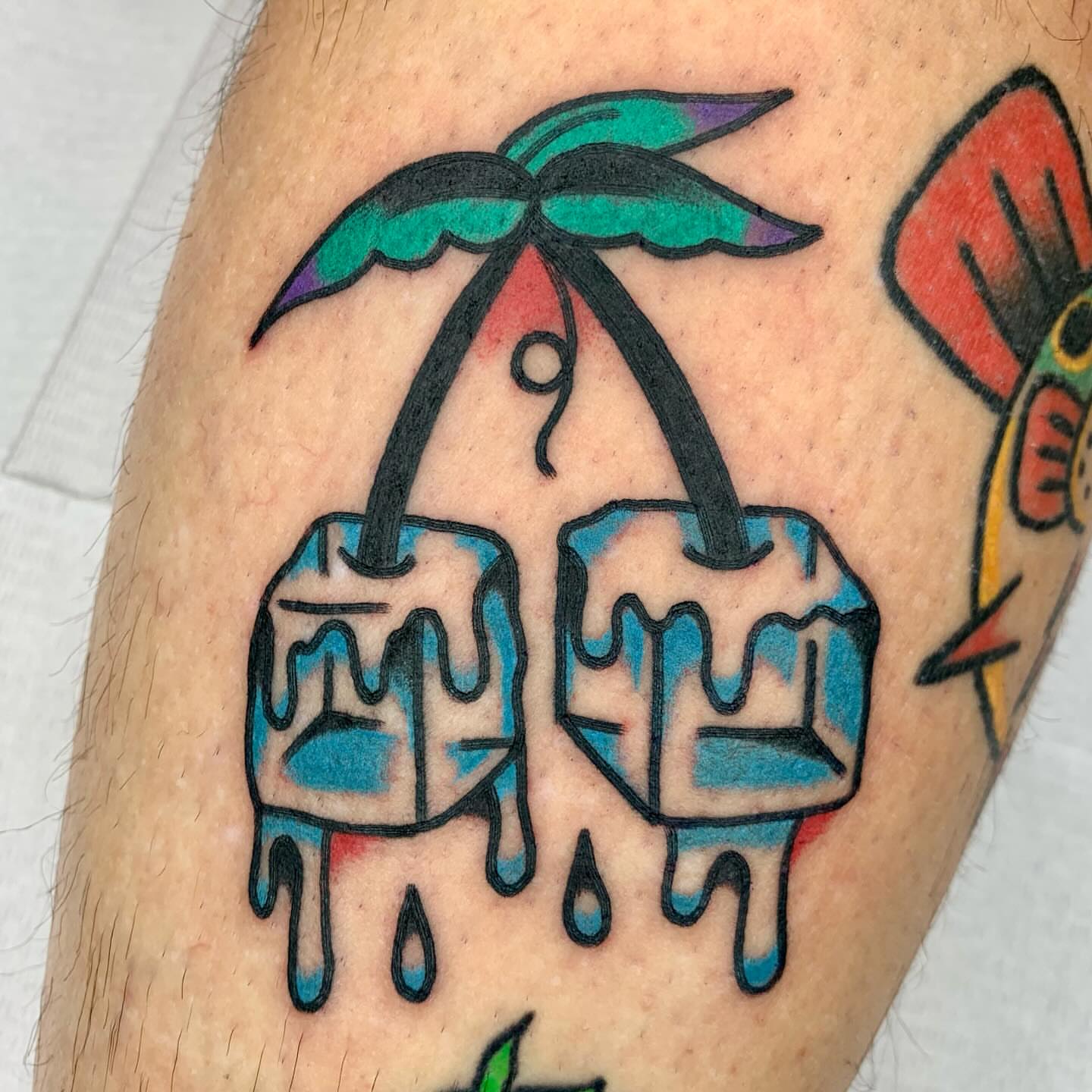 Melting ice cubes American traditional tattoo on the forearm by Keegan Bergen