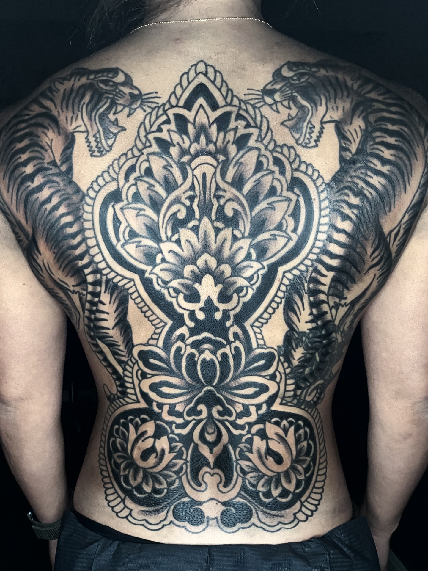 Lotus and snakes ornamental tattoo on the back by Lisa Del Toro