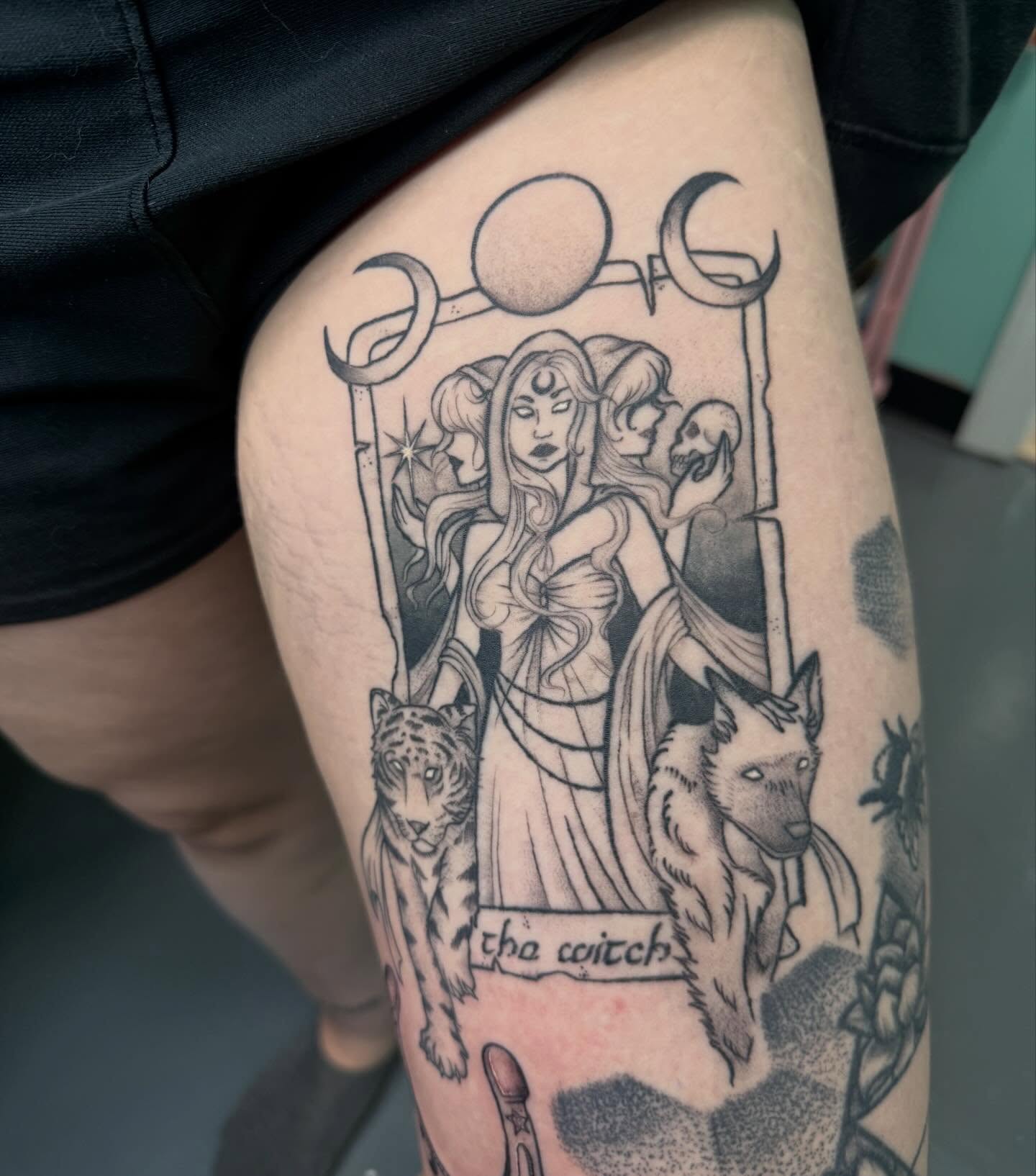 The witch black and grey tattoo on the thigh by Bry