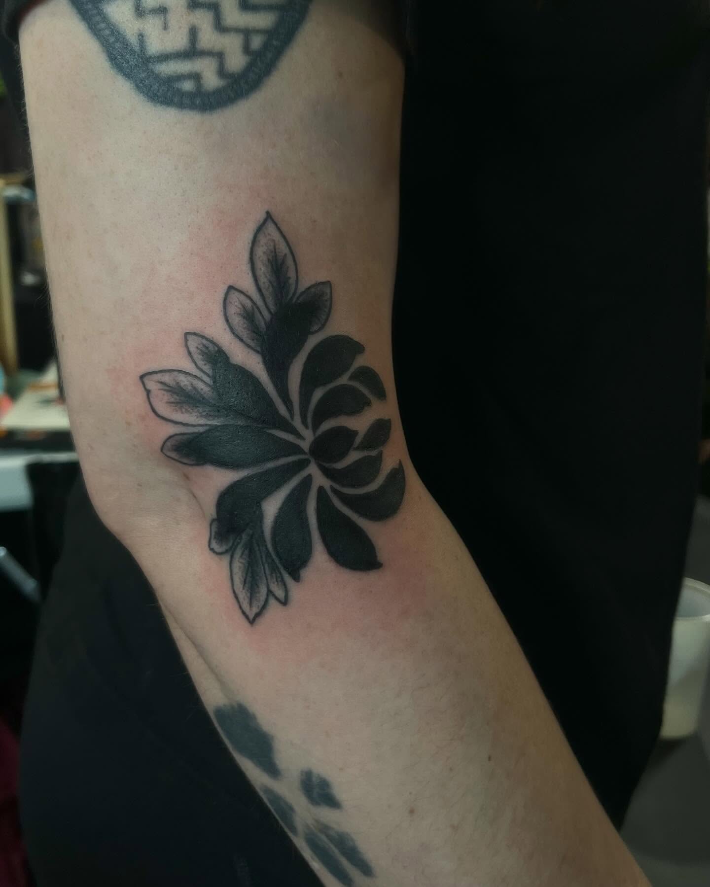 Lotus flower black and grey tattoo on the forearm by Garden Glow Tattoo