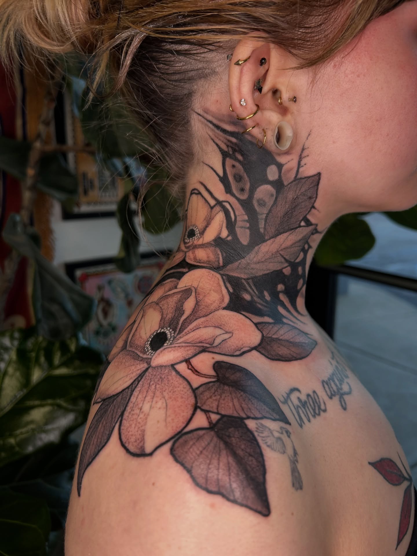 Flowers black and grey tattoo on the shoulder by Amber Miracle