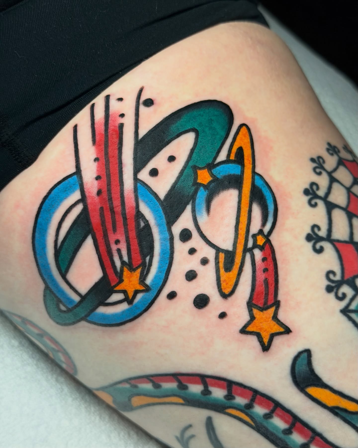 Space-themed design American traditional tattoo on the thigh by Kyle Dean Traditional Tattoo Artist
