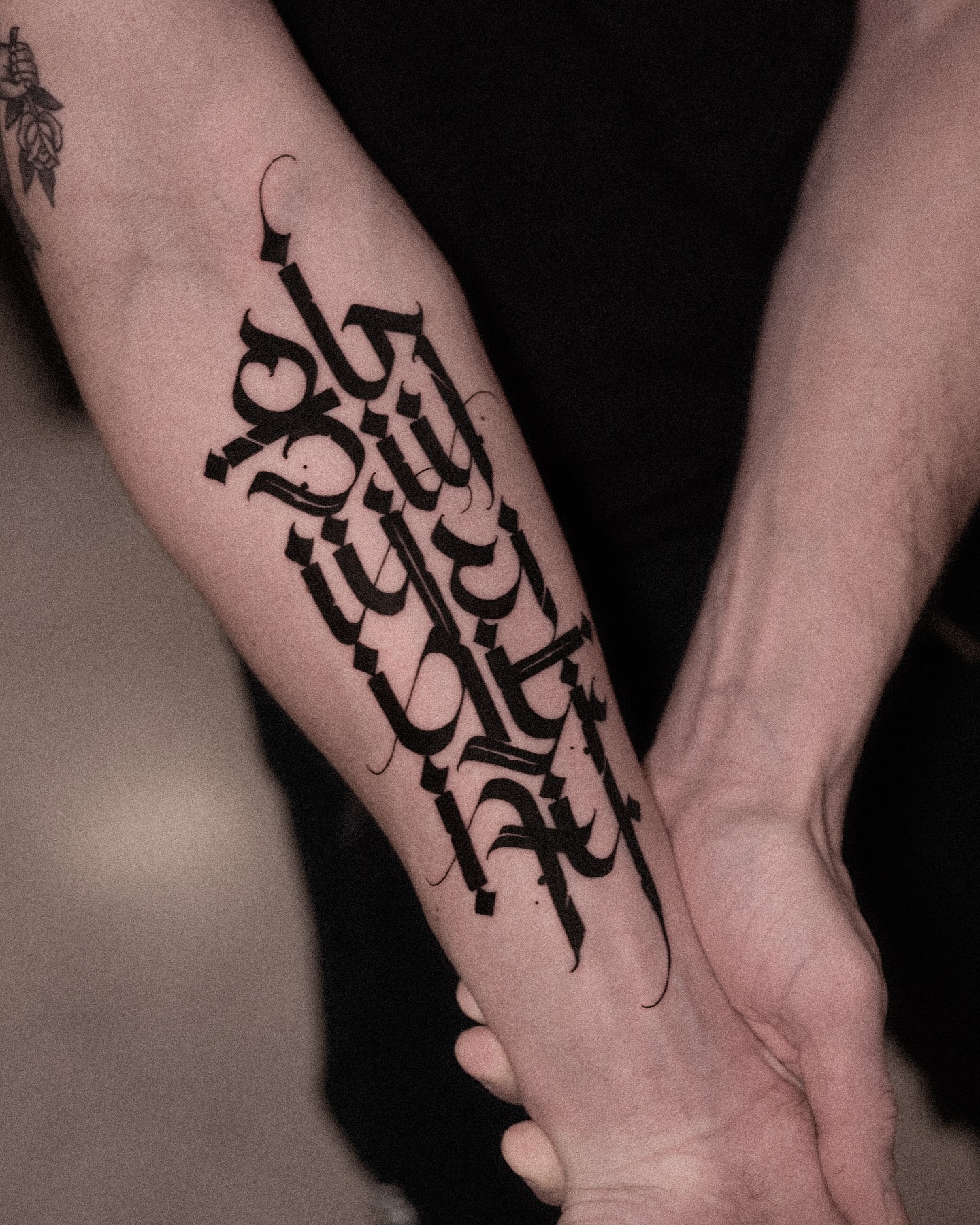Gothic calligraphy Chicano tattoo on the forearm by Low, Brooklyn, New York