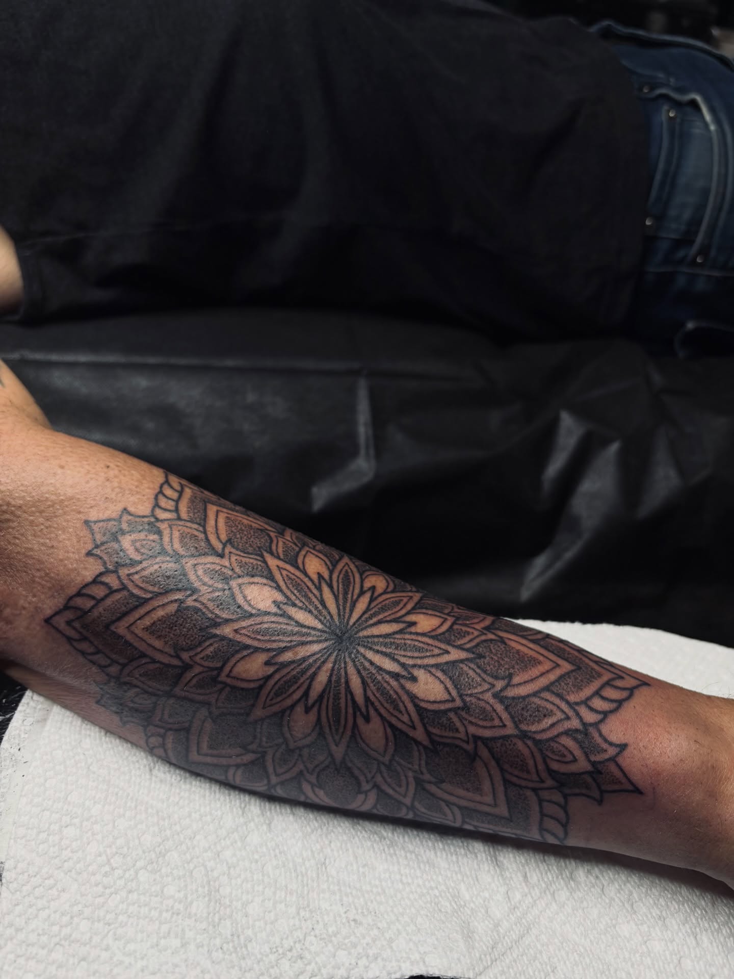 Mandala black and grey tattoo on the forearm by Kolbi Alexis