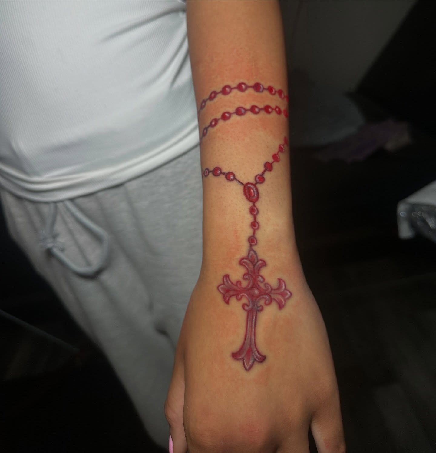Rosary cross dotwork tattoo on the forearm by @tattedbytuck