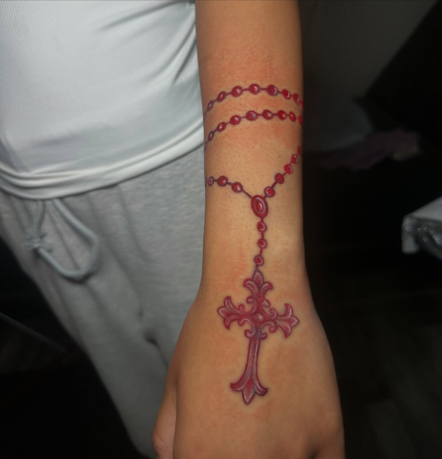 Rosary and cross neo-traditional tattoo on the forearm by @tattedbytuck