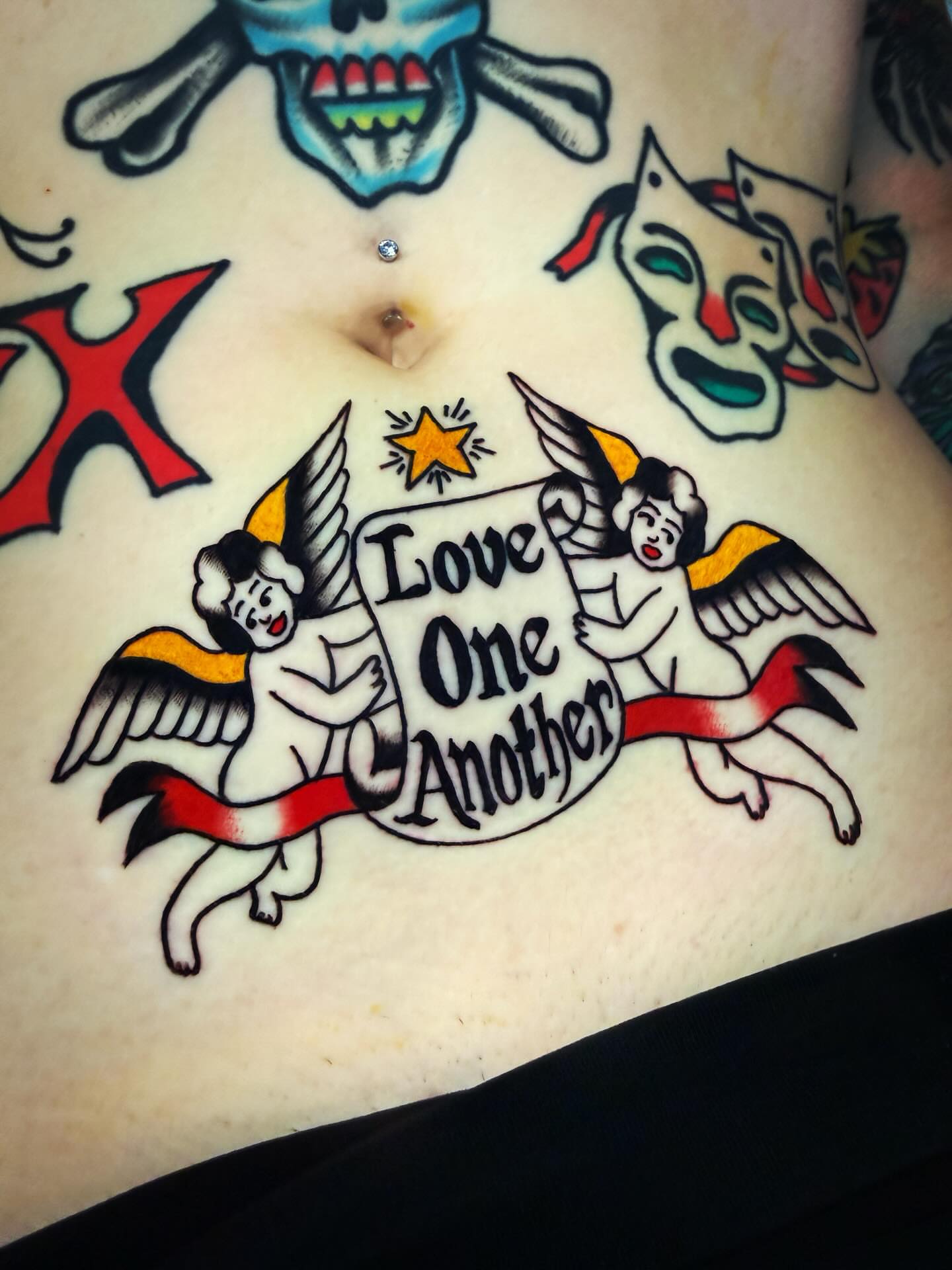 Angels with banner American traditional tattoo on the torso by Britt Kuechenmeister, Culver City, California