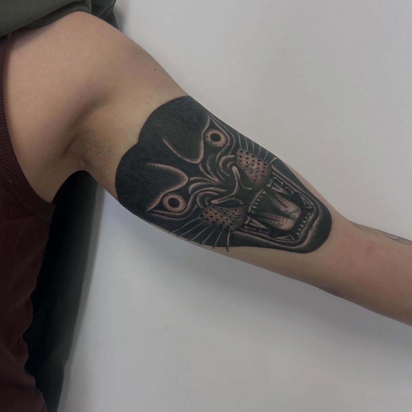 Mask realism tattoo on the forearm by Alex Lang