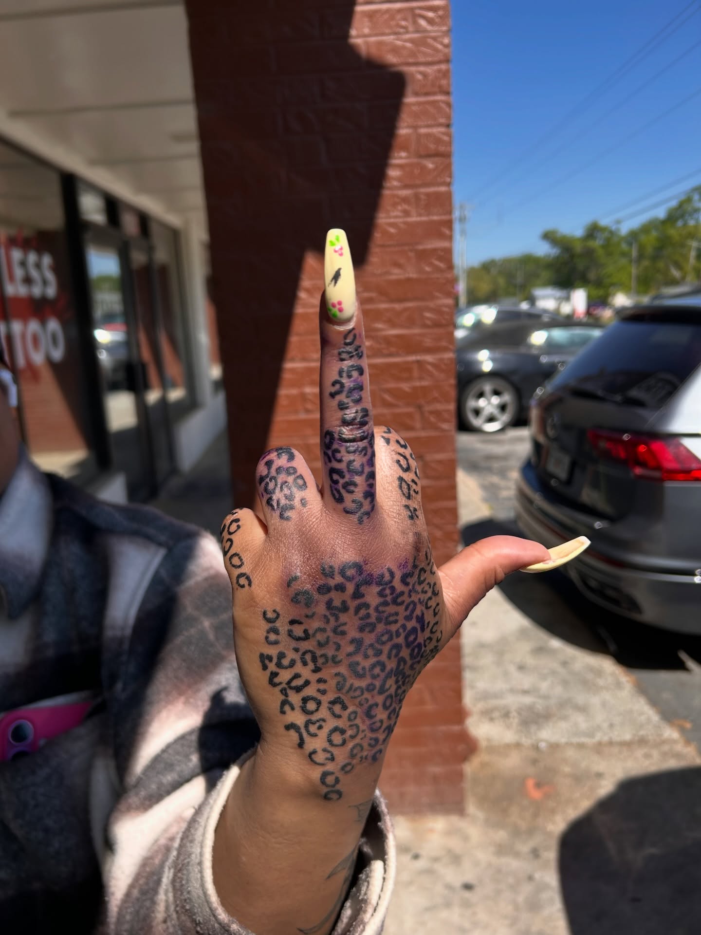 Cheetah print black and grey tattoo on the hand by Nigel🪓UNO