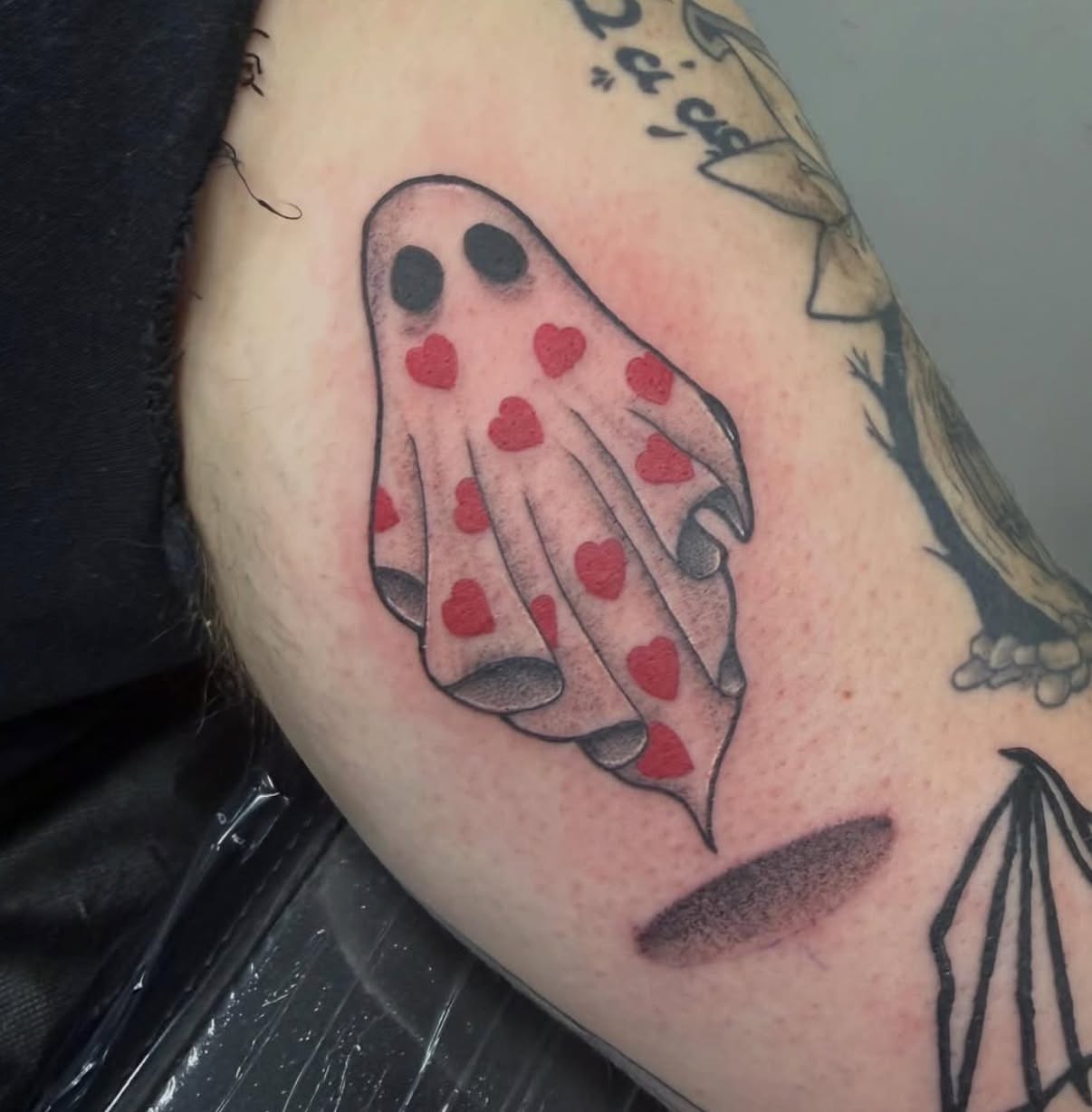 Ghost with hearts dotwork tattoo on the forearm by Matt Hattaway