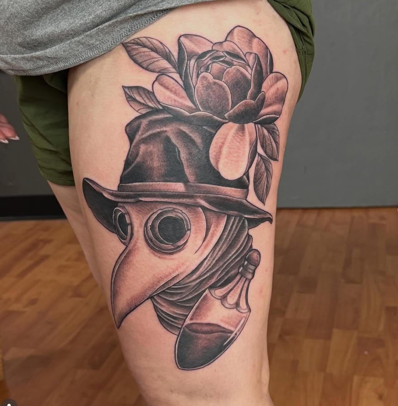 Plague doctor mask and flower realism tattoo on the thigh by Matt Hattaway