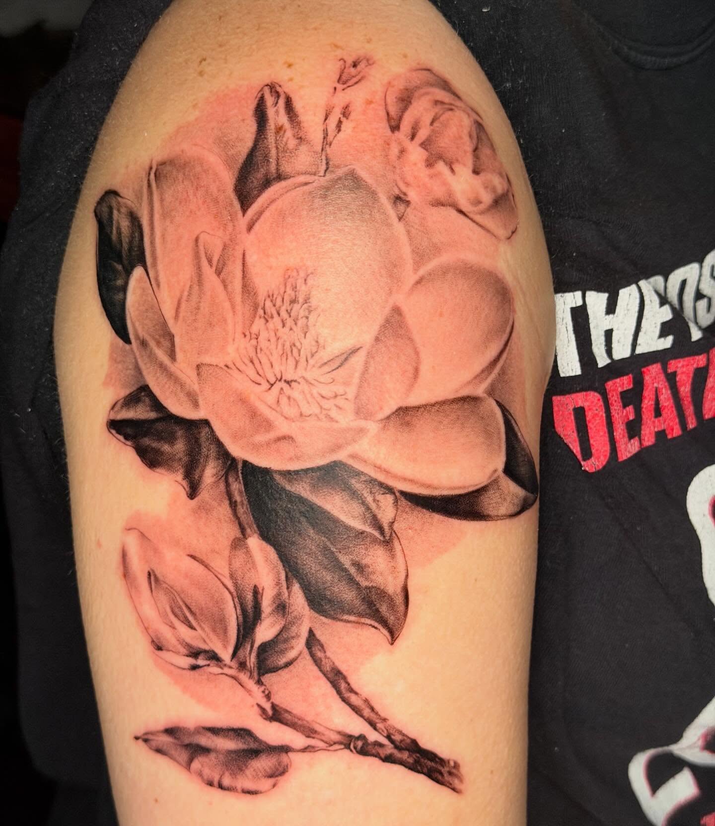 Lotus flower realism tattoo on the upper arm by James Nelson