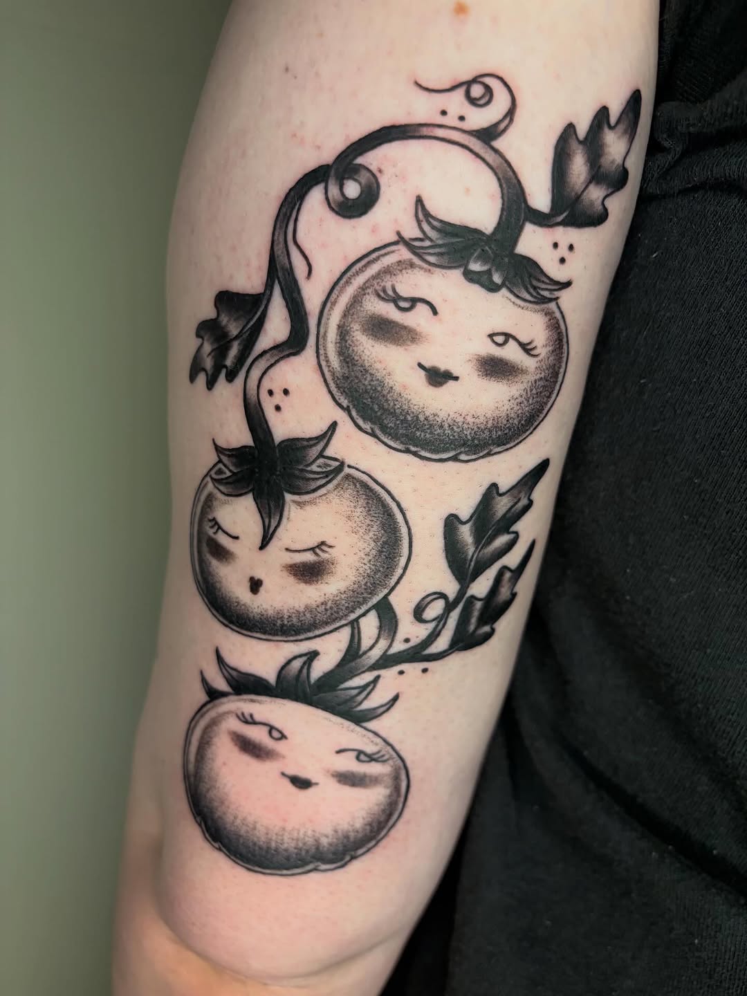 Anthropomorphic tomatoes on vine dotwork tattoo on the forearm by Fin :