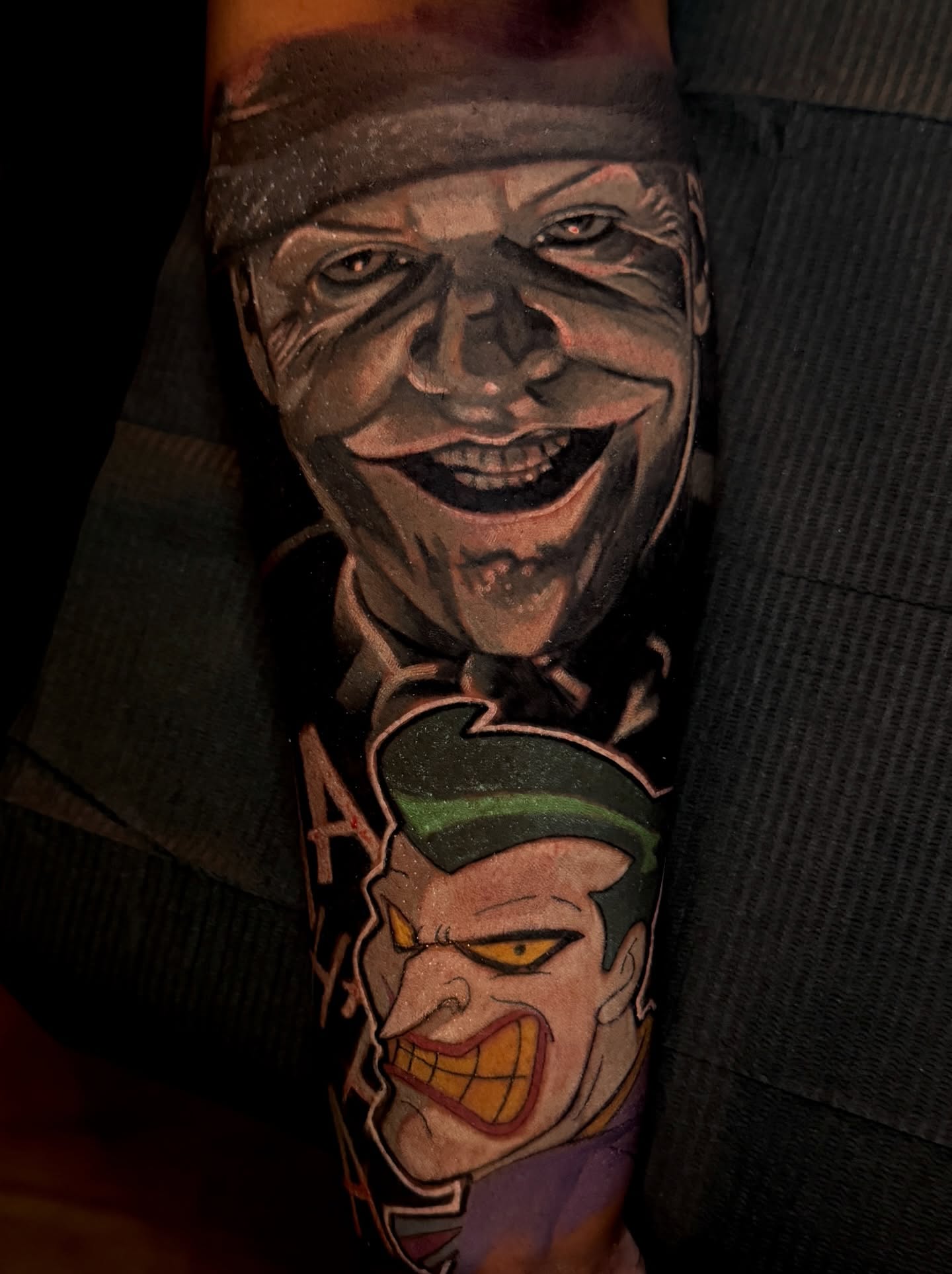 Joker and clown realism tattoo on the forearm by Scott Pizer