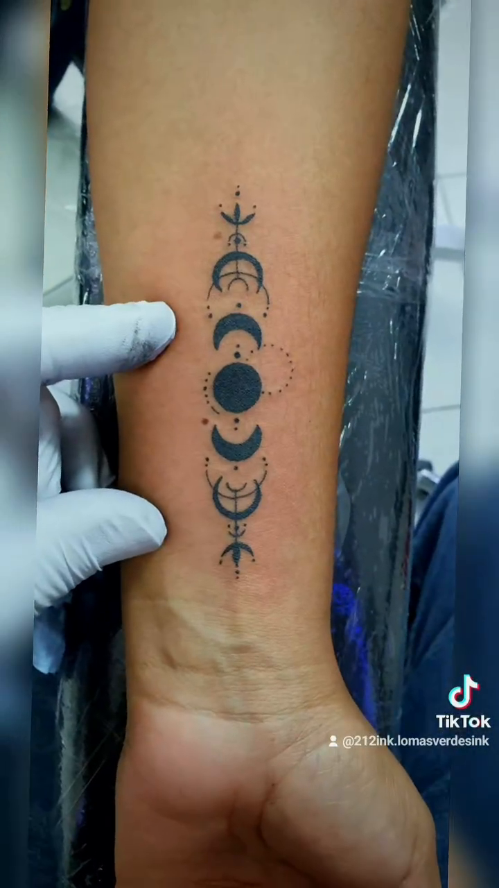 Moon phases and symbols ornamental tattoo on the upper arm by Tatuajes Betto Ink Tattoo