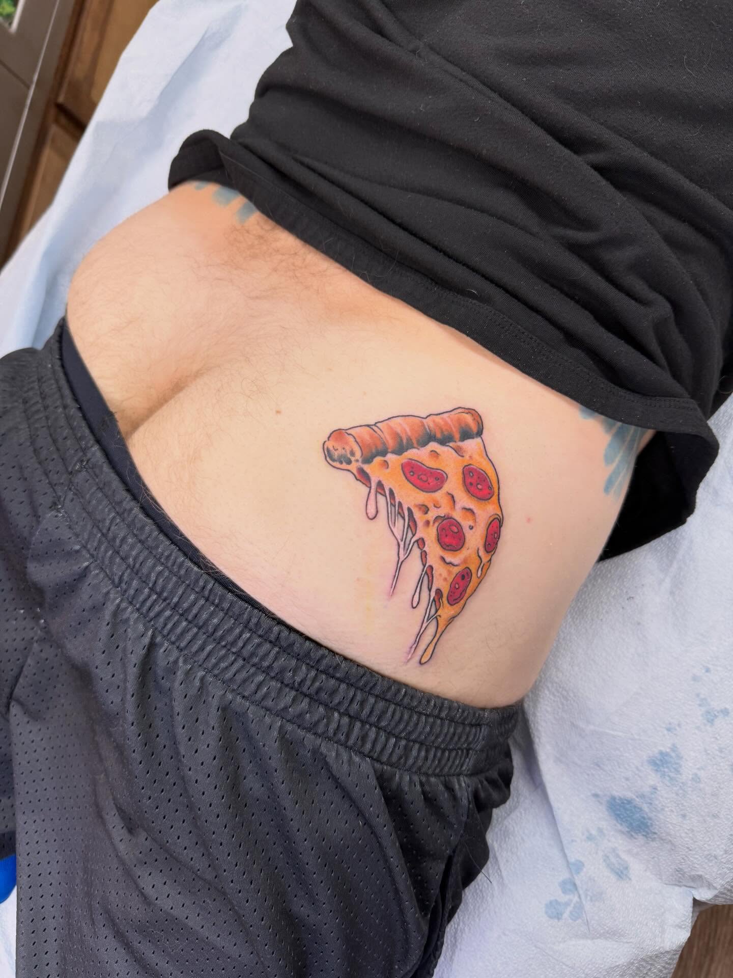 Pizza slice realism tattoo by Hori Bensei, Charlottesville, Virginia