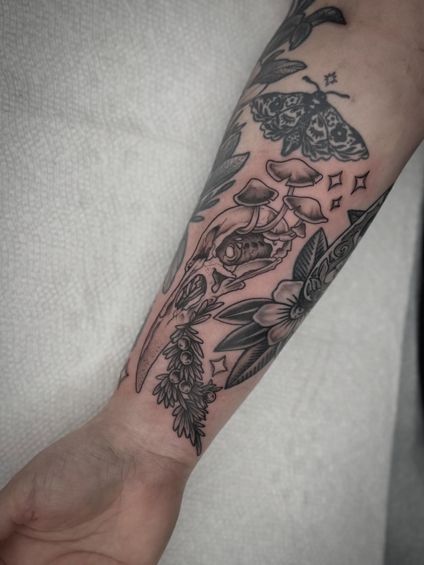 Mushroom and moth black and grey tattoo on the forearm by mia palau