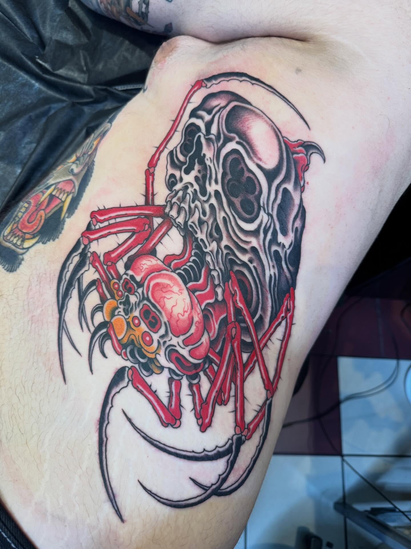 Skull and spider dark realism tattoo on the thigh by Derek Noble, San Francisco, California