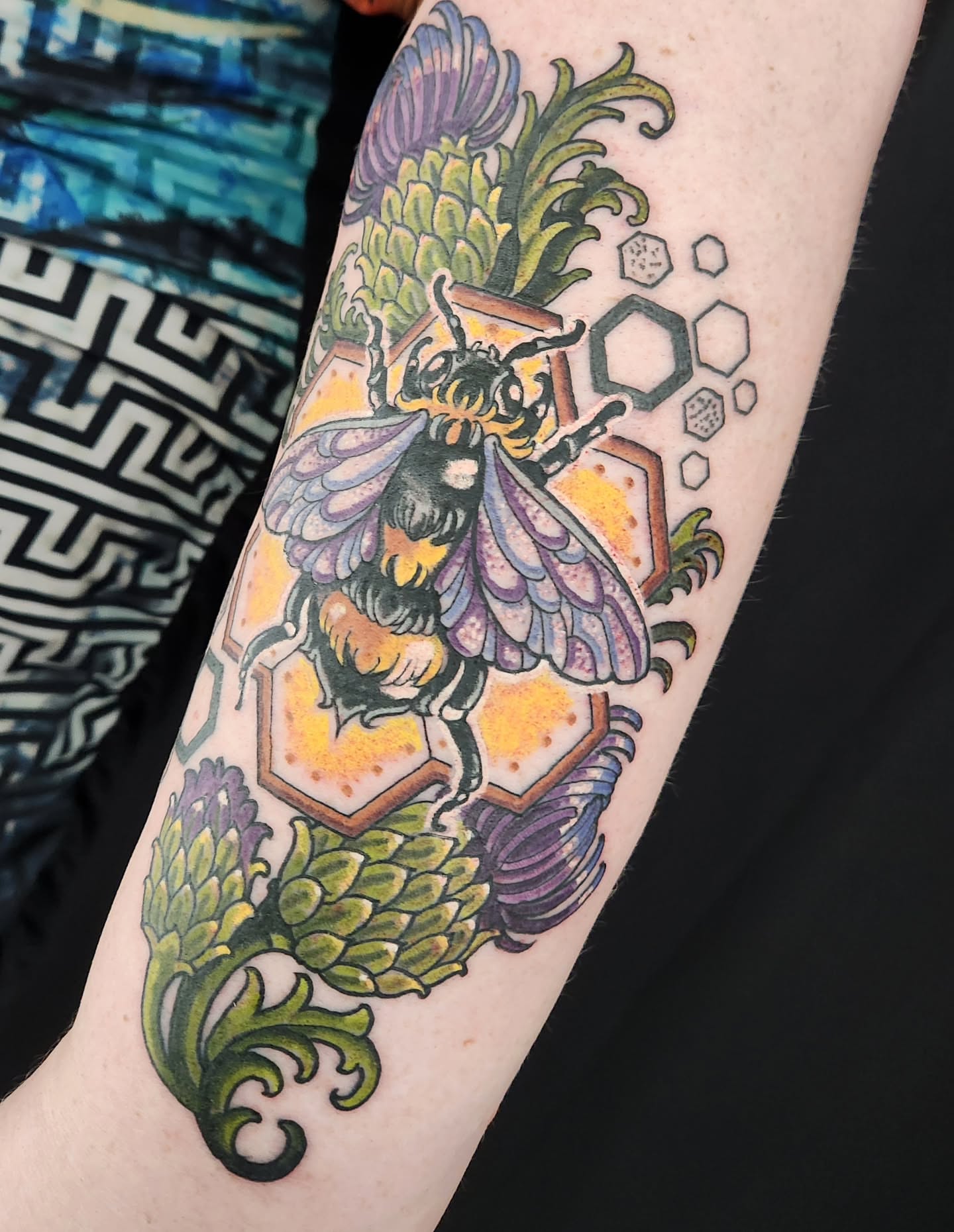 Bee and thistle geometric tattoo on the forearm by Randy
