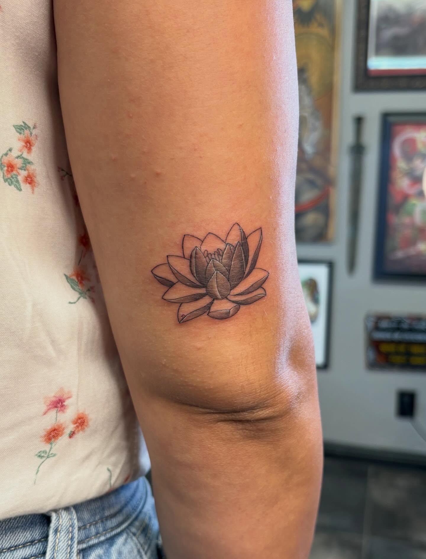 Lotus flower black and grey tattoo on the forearm by alana khounmeuang