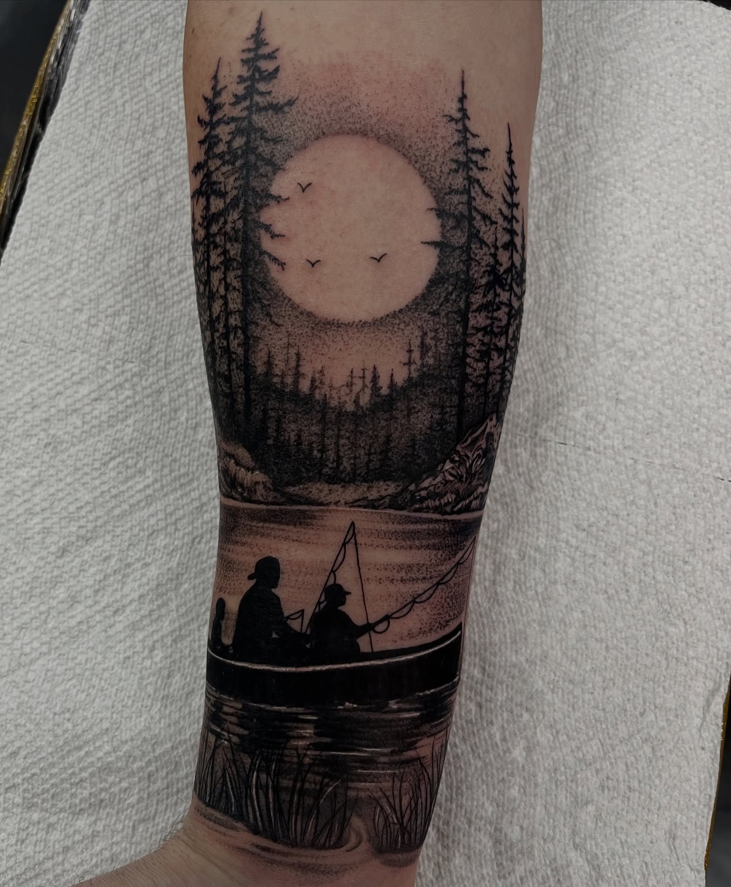 Fishing scene dotwork tattoo on the forearm by Jordan Hunt