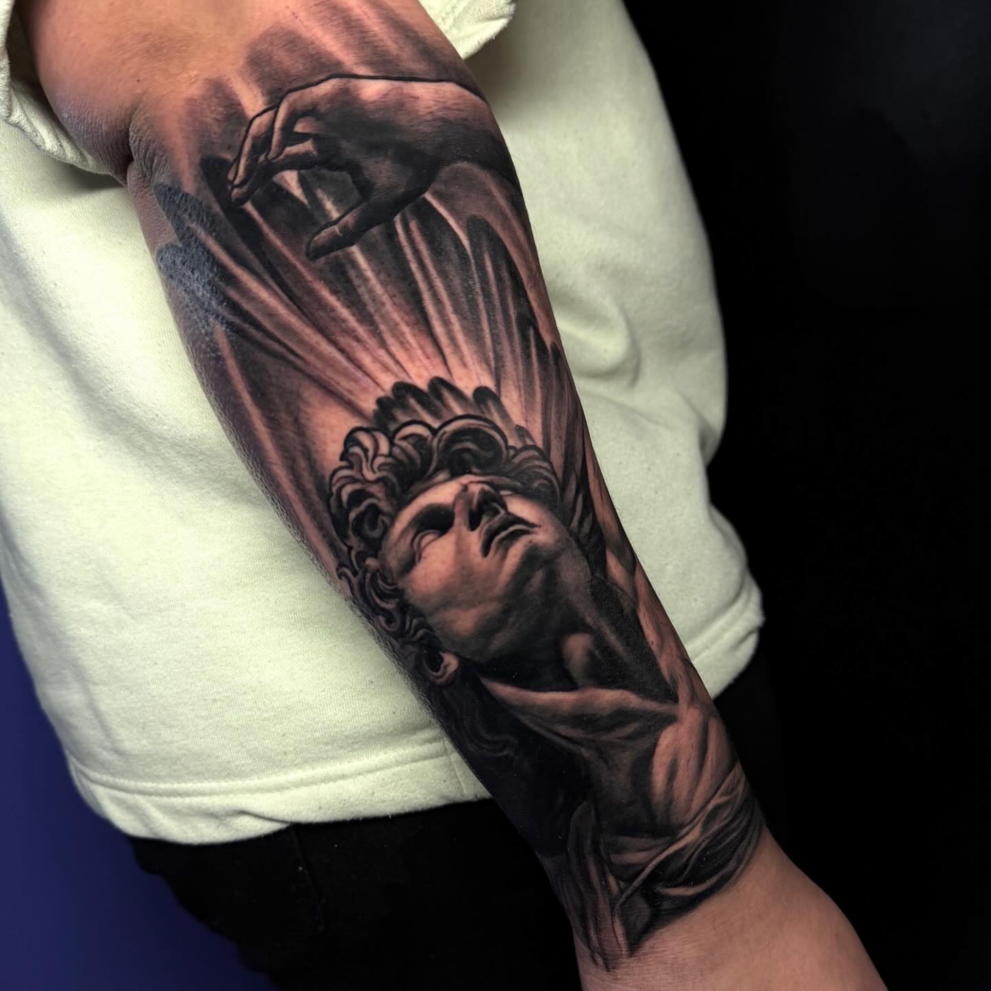 Statue head realism tattoo on the forearm by Corey Ryan