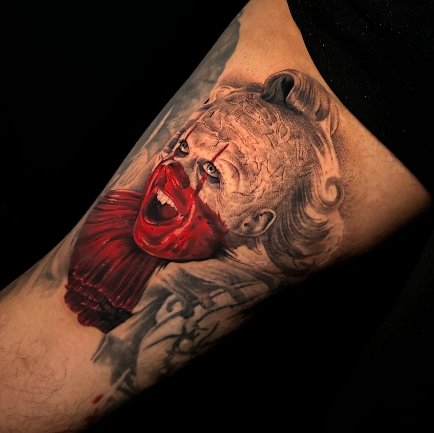 Clown head realism tattoo on the forearm by Breah Beshore Kirk