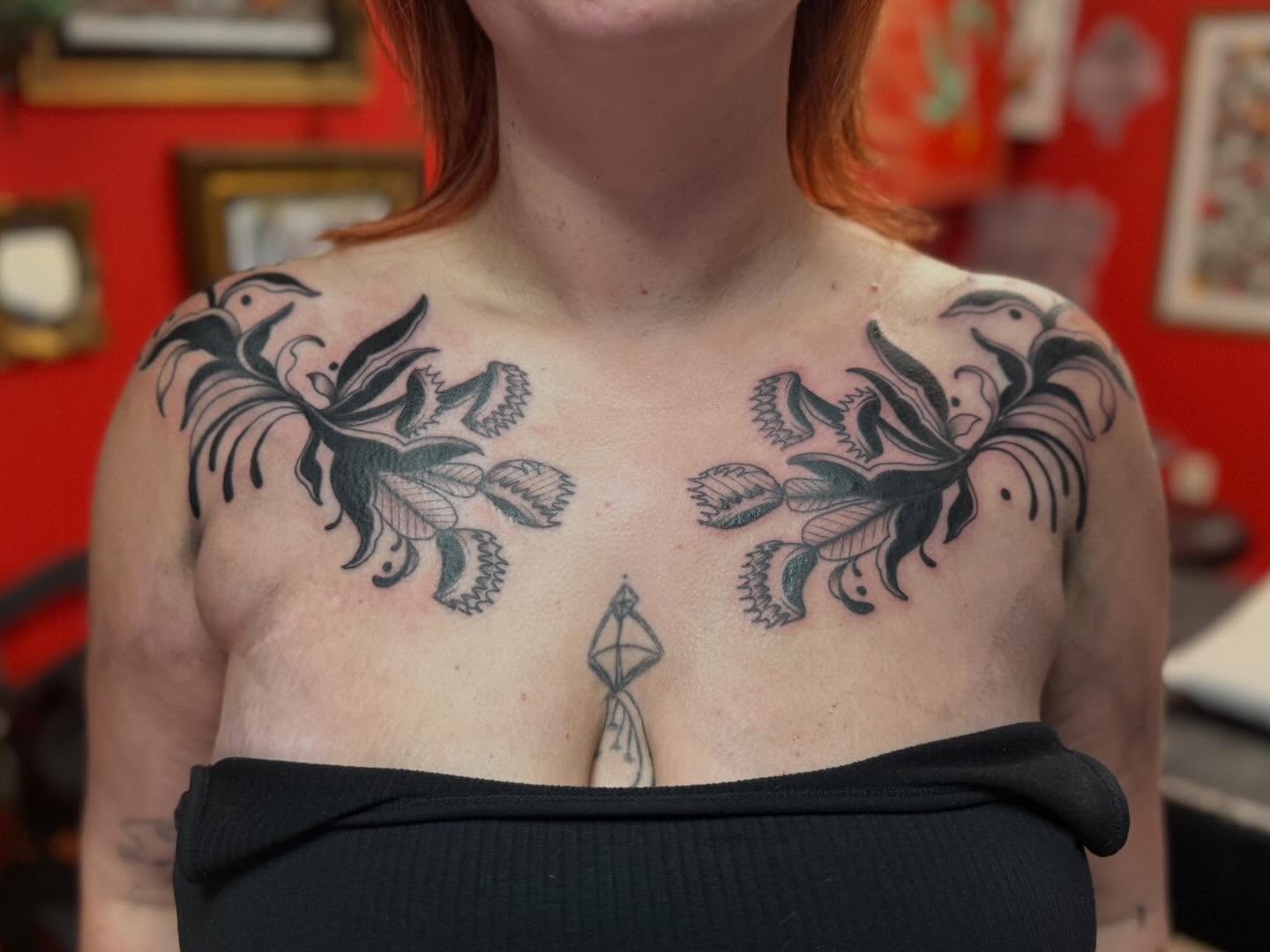 Floral black and grey tattoo on the chest by Jacqui Rose