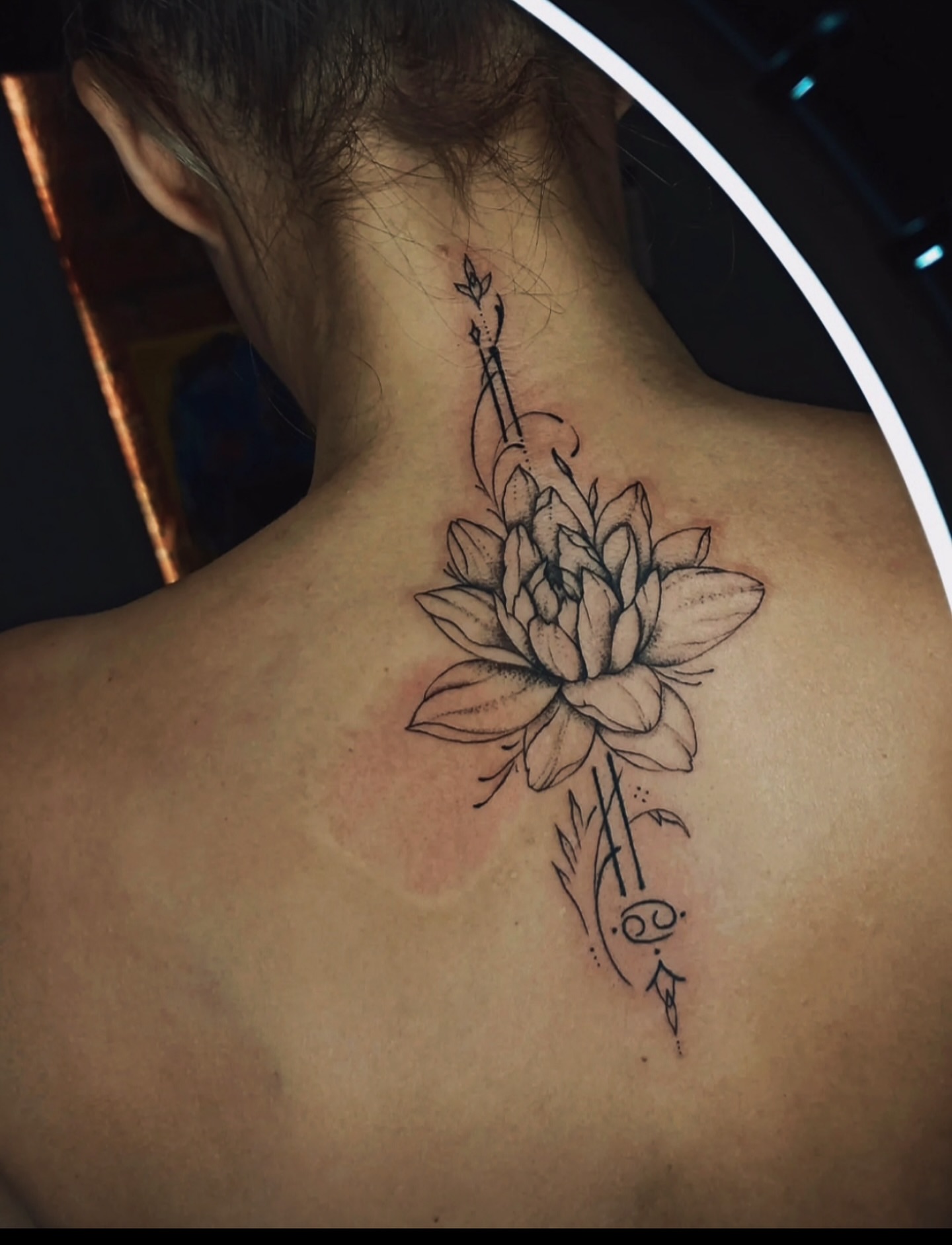 Lotus flower black and grey tattoo on the back by Sacramento tattoo