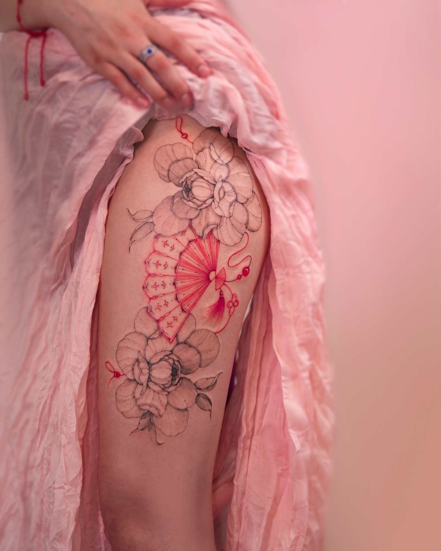 Floral fan dotwork tattoo on the thigh by Zalina Loriia