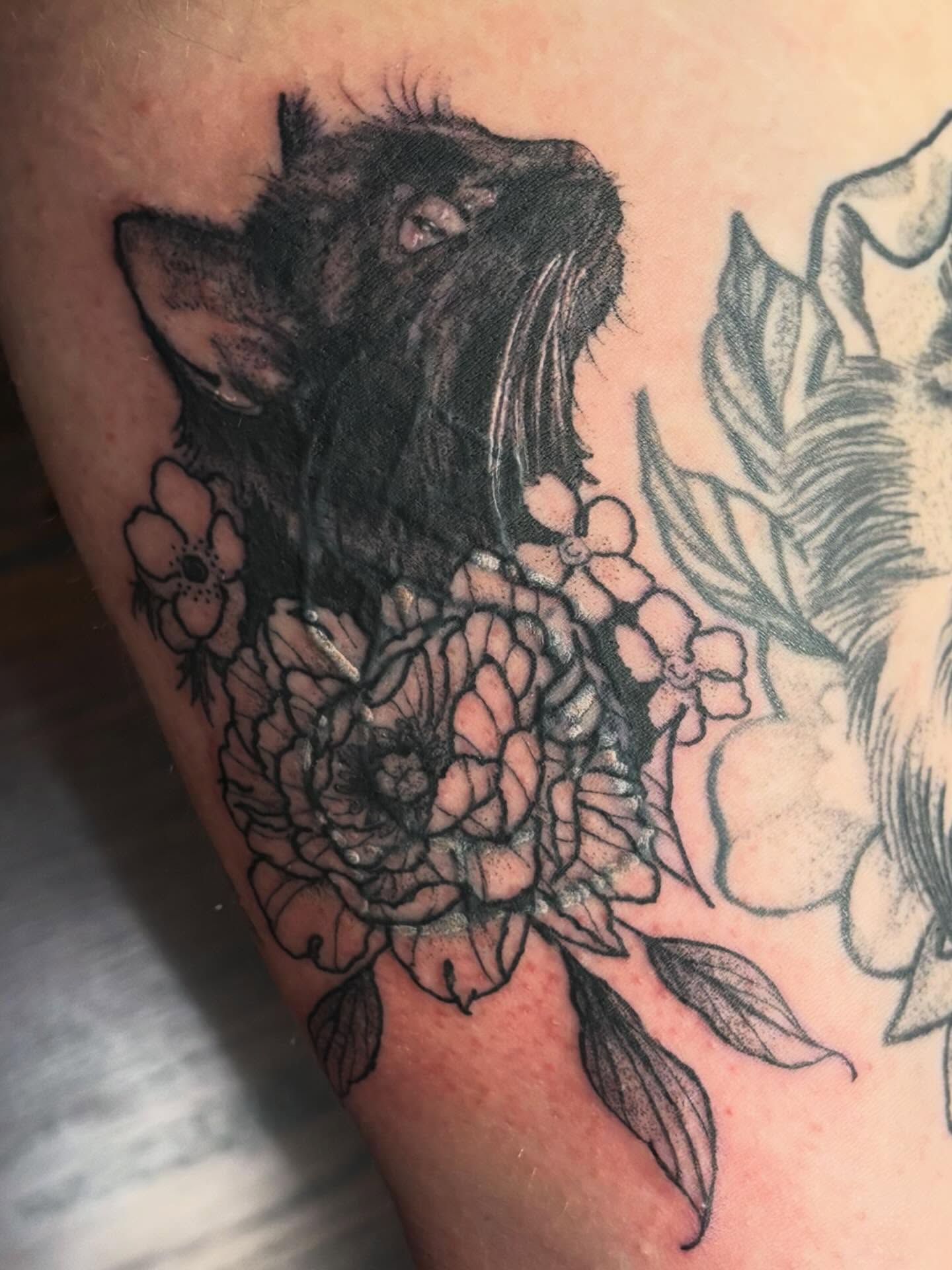Cat and flowers realism tattoo on the thigh by kane