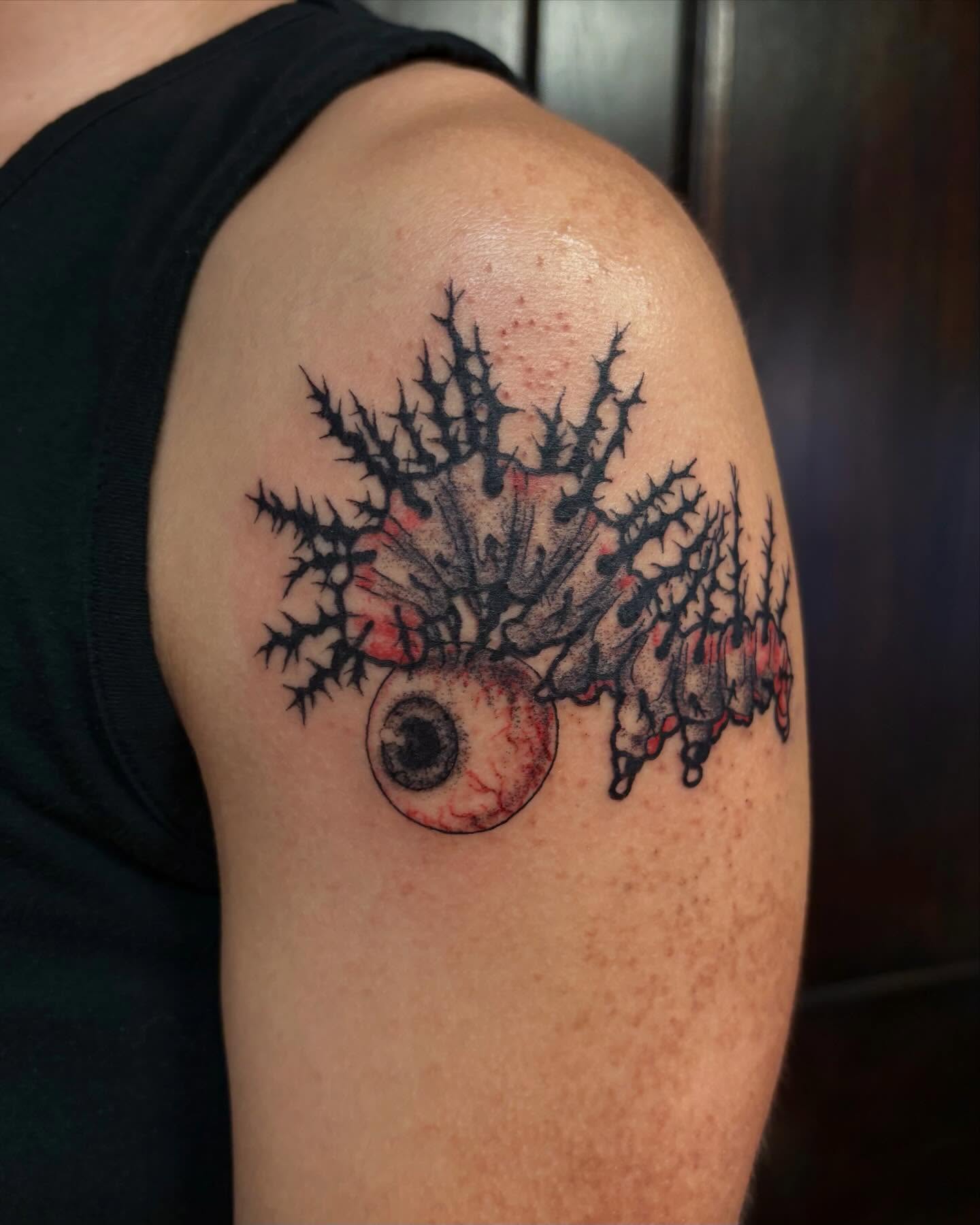 Eye with thorny branches dark realism tattoo on the shoulder by kane