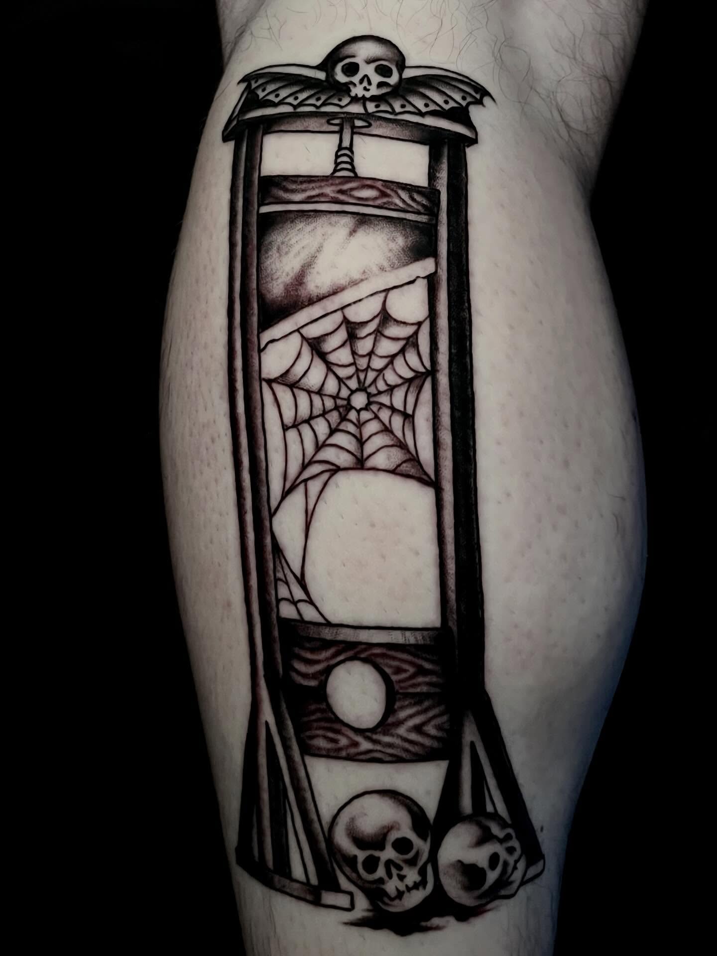 Hourglass with skulls black and grey tattoo on the forearm by JohnJohn