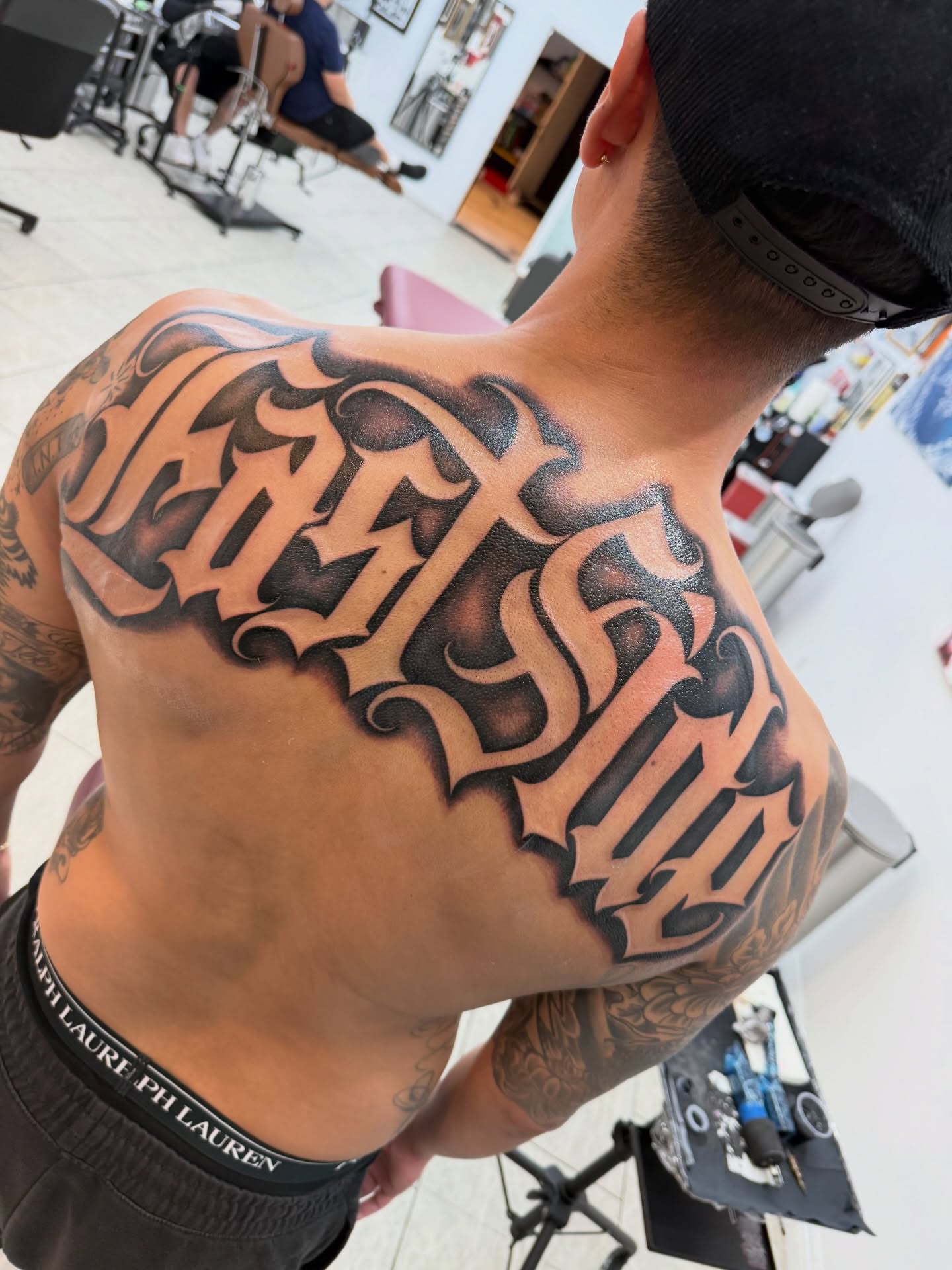 Script lettering lettering script tattoo on the back by Daniel Lopez Tattoos