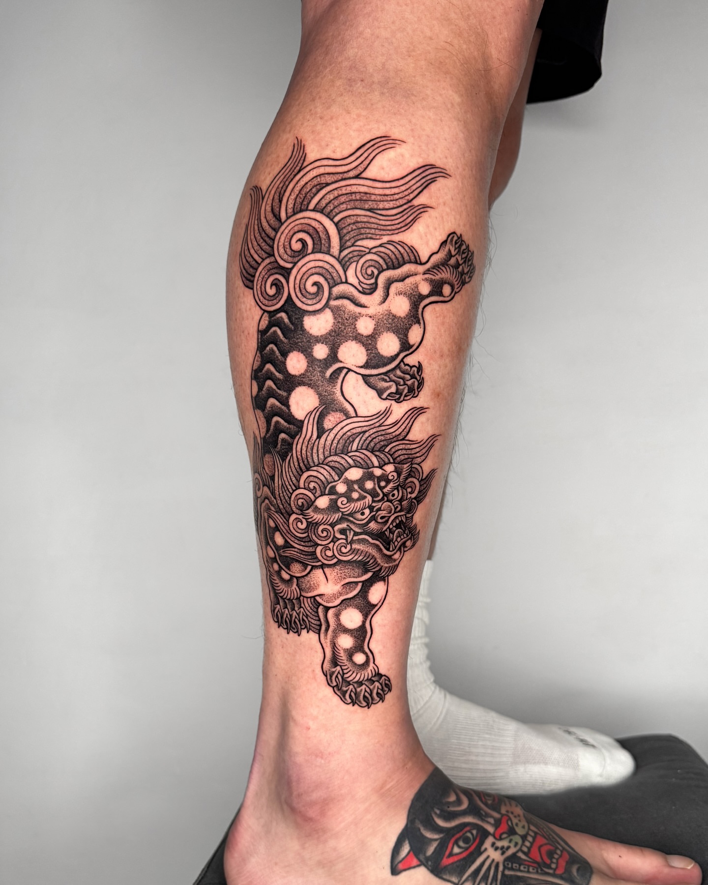 Dragon dotwork tattoo on the calf by Jae Traditional Tattoo
