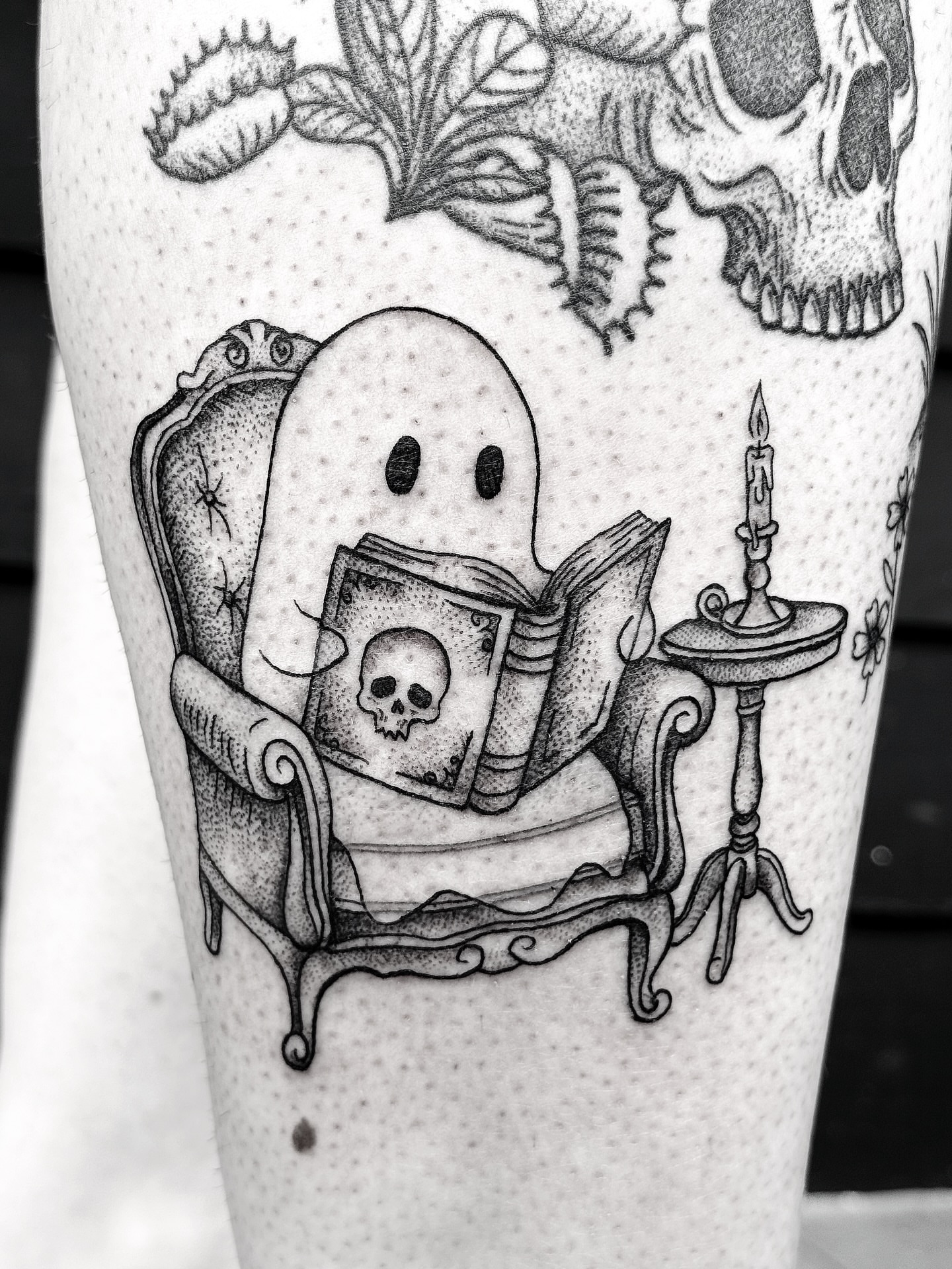 Ghost reading book dotwork tattoo on the forearm by Breezy Tucker