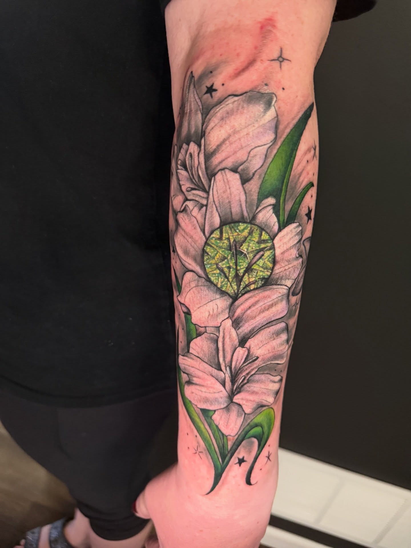 Lilies realism tattoo on the forearm by Michelle Balhan