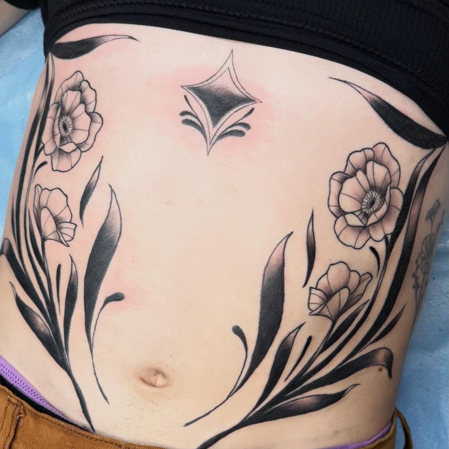 Floral design black and grey tattoo on the torso by Bri ⚡️✨