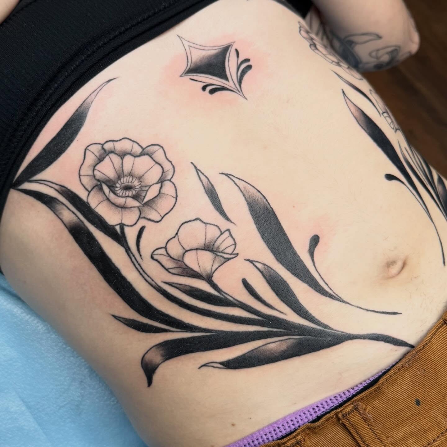 Flower black and grey tattoo on the torso by Bri ⚡️✨