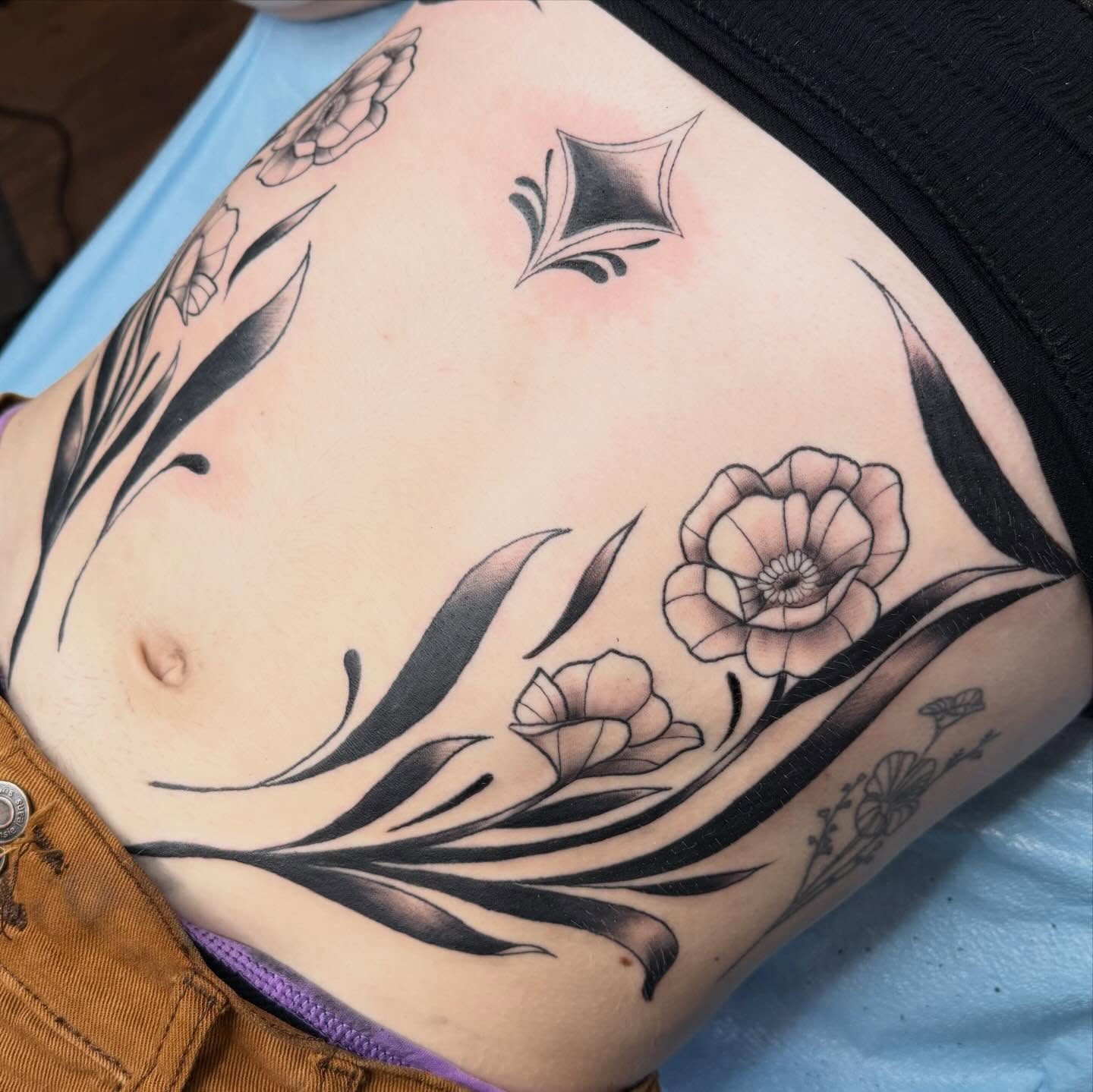 Floral design black and grey tattoo on the ribs by Bri ⚡️✨