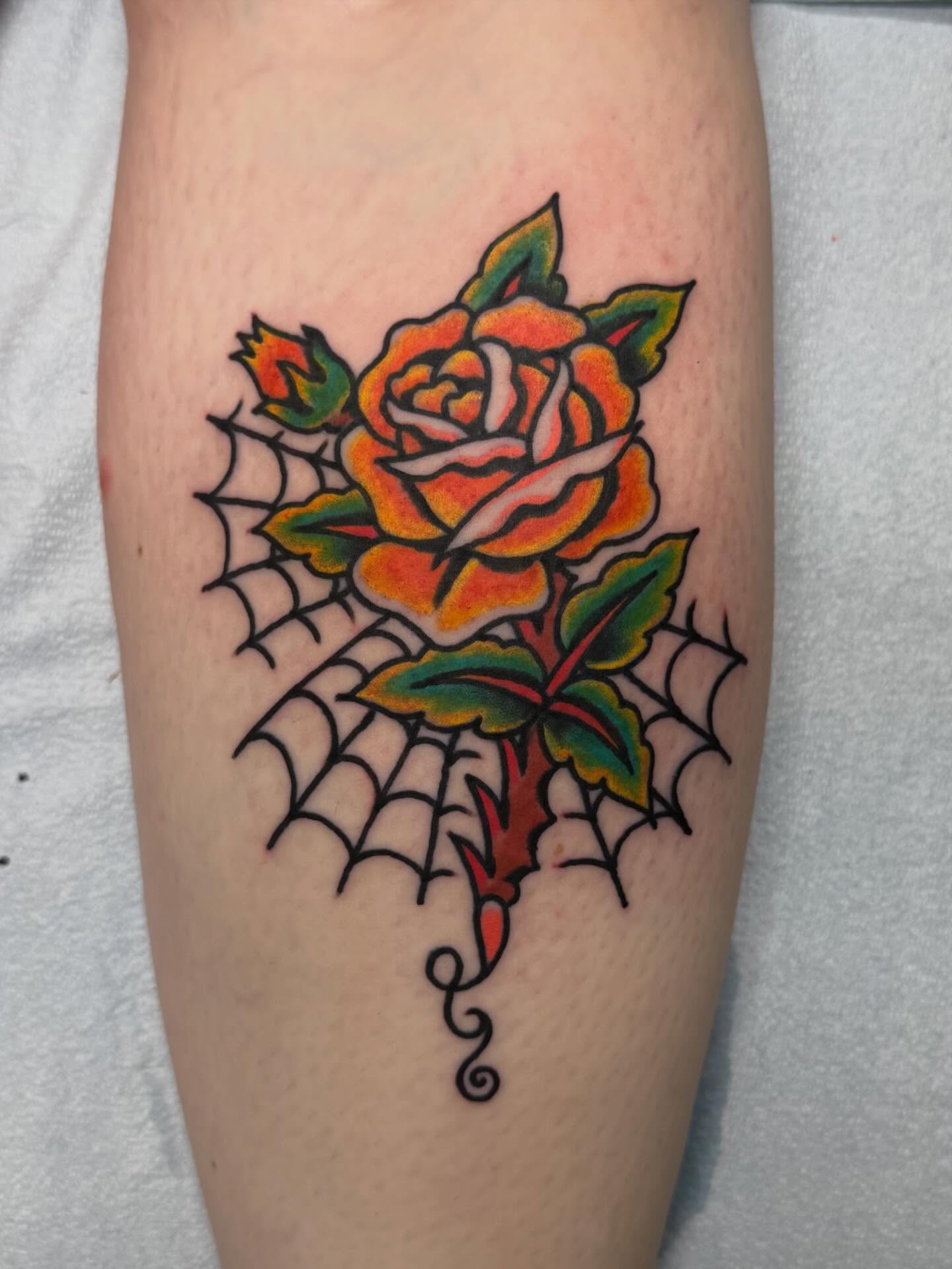 Rose with spiderweb American traditional tattoo on the forearm by Bill Crawford, Plymouth, Michigan
