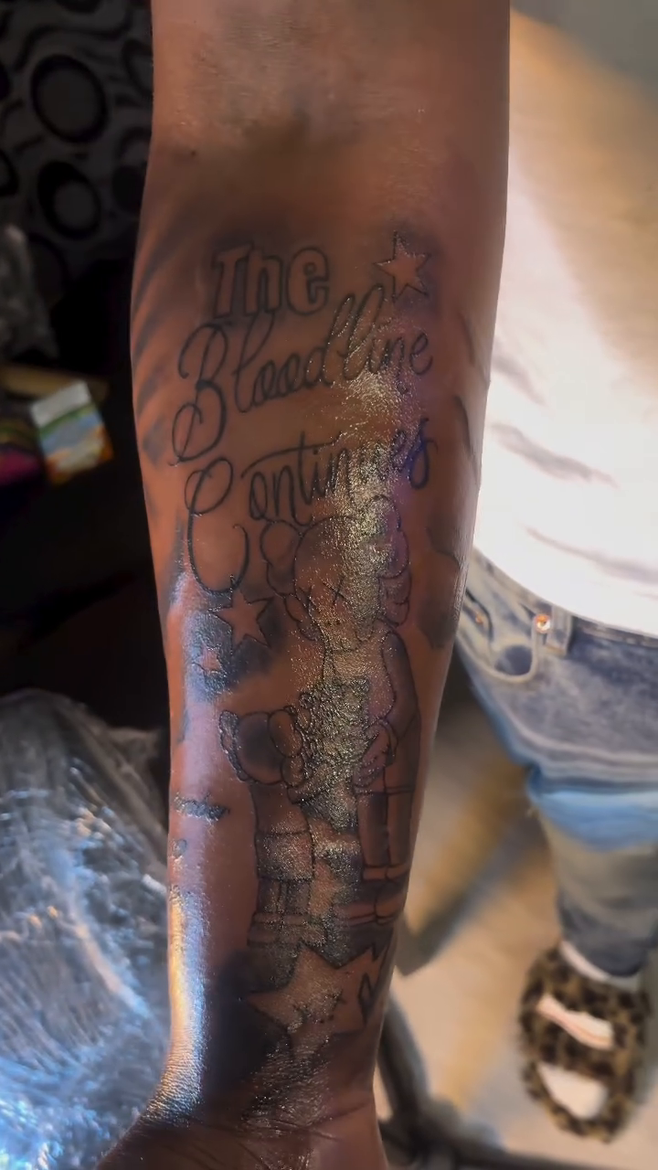 Lettering tattoo on the upper arm by TP