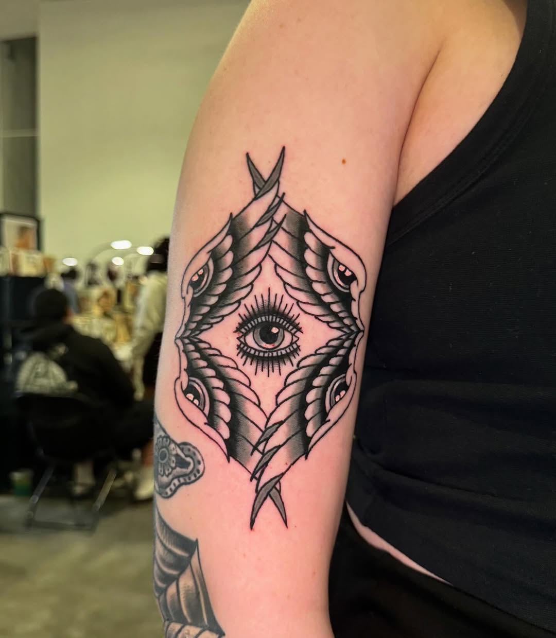 All-seeing eye with wings geometric tattoo on the forearm by @michaelryan_tattoo