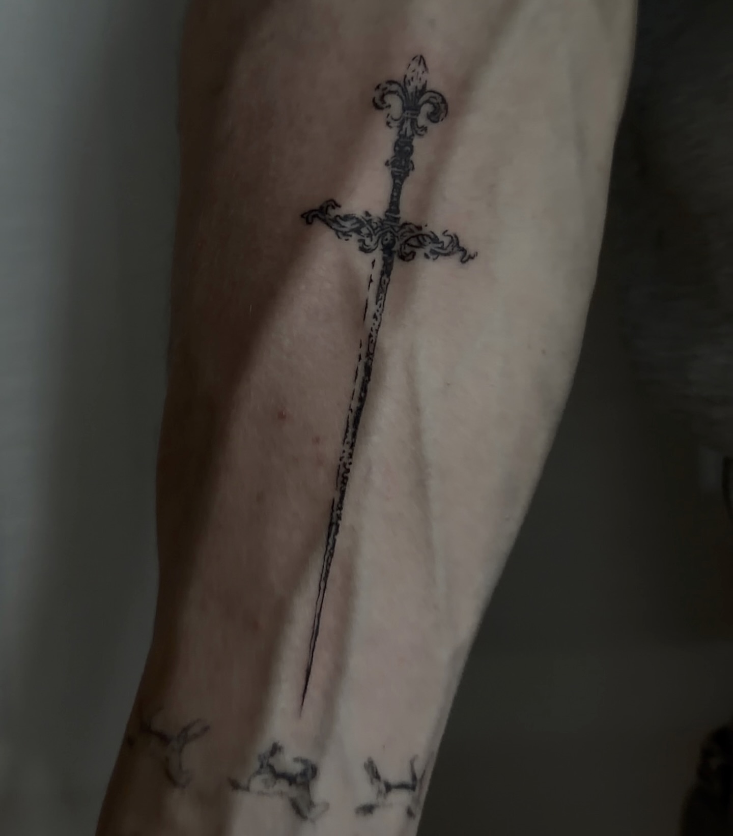 Sword black and grey tattoo on the forearm by Casper Tattoos Toronto