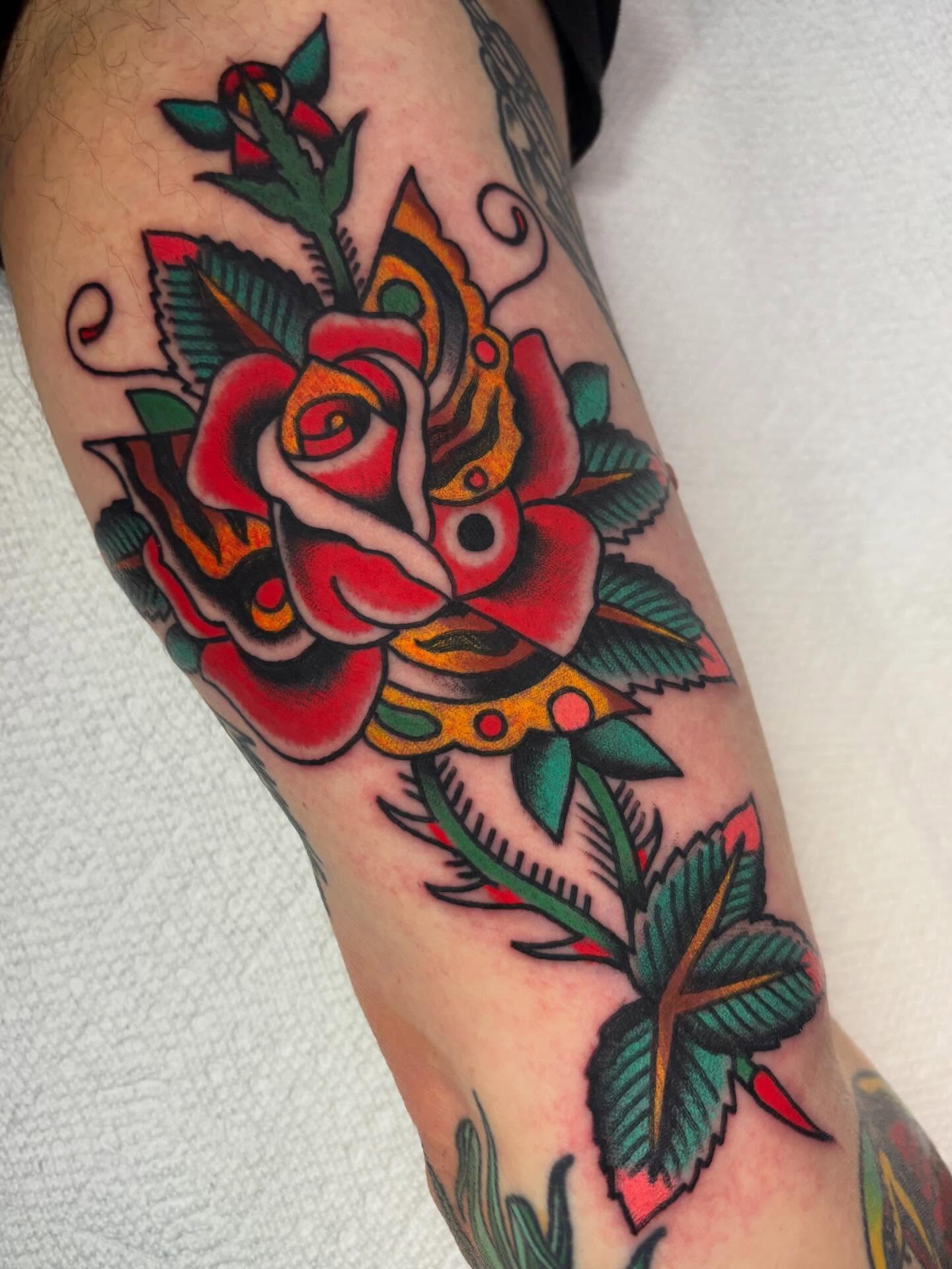 Rose American traditional tattoo on the forearm by Chris Dufresne